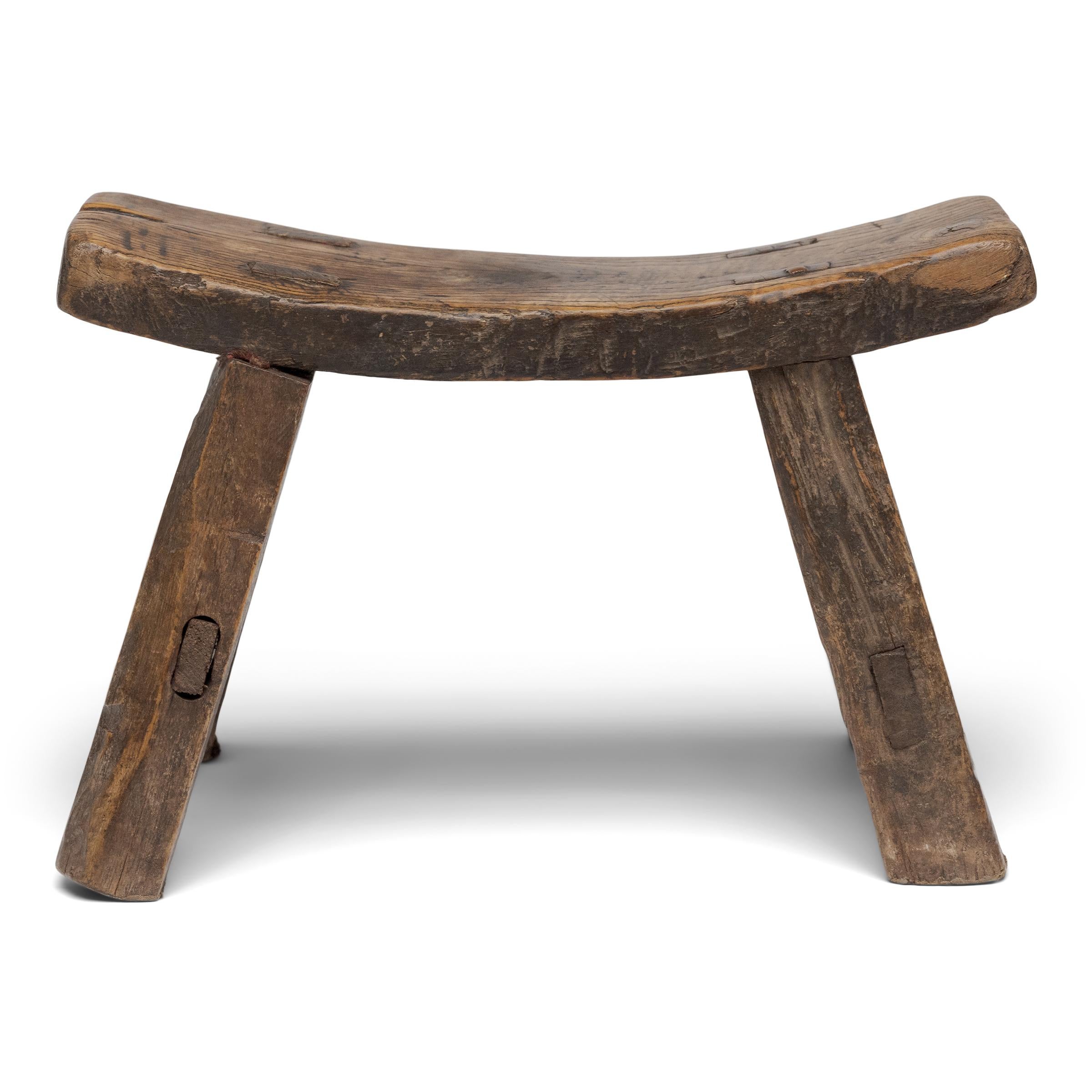 This low, four-leg stool is actually a 19th-century headrest used atop a daybed or mat to support the head while sleeping, reclining, or smoking opium. As an opium accessory, rigid headrests such as this allowed an inebriated smoker to to more