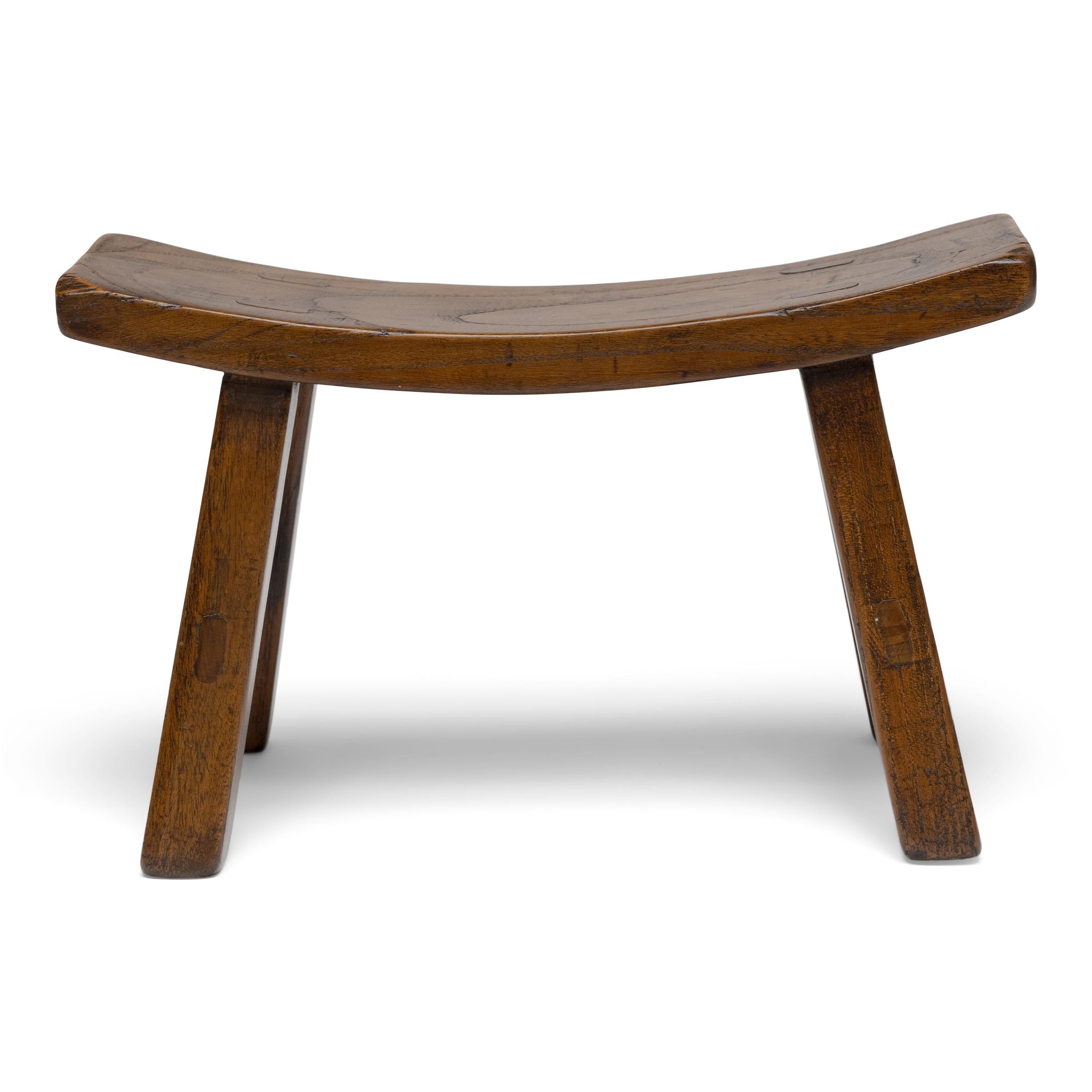 This low, four-leg stool is actually a headrest used atop a daybed or mat to support the head while sleeping, reclining, or smoking opium. As an opium accessory, rigid headrests such as this allowed an inebriated smoker to to more comfortably lie on