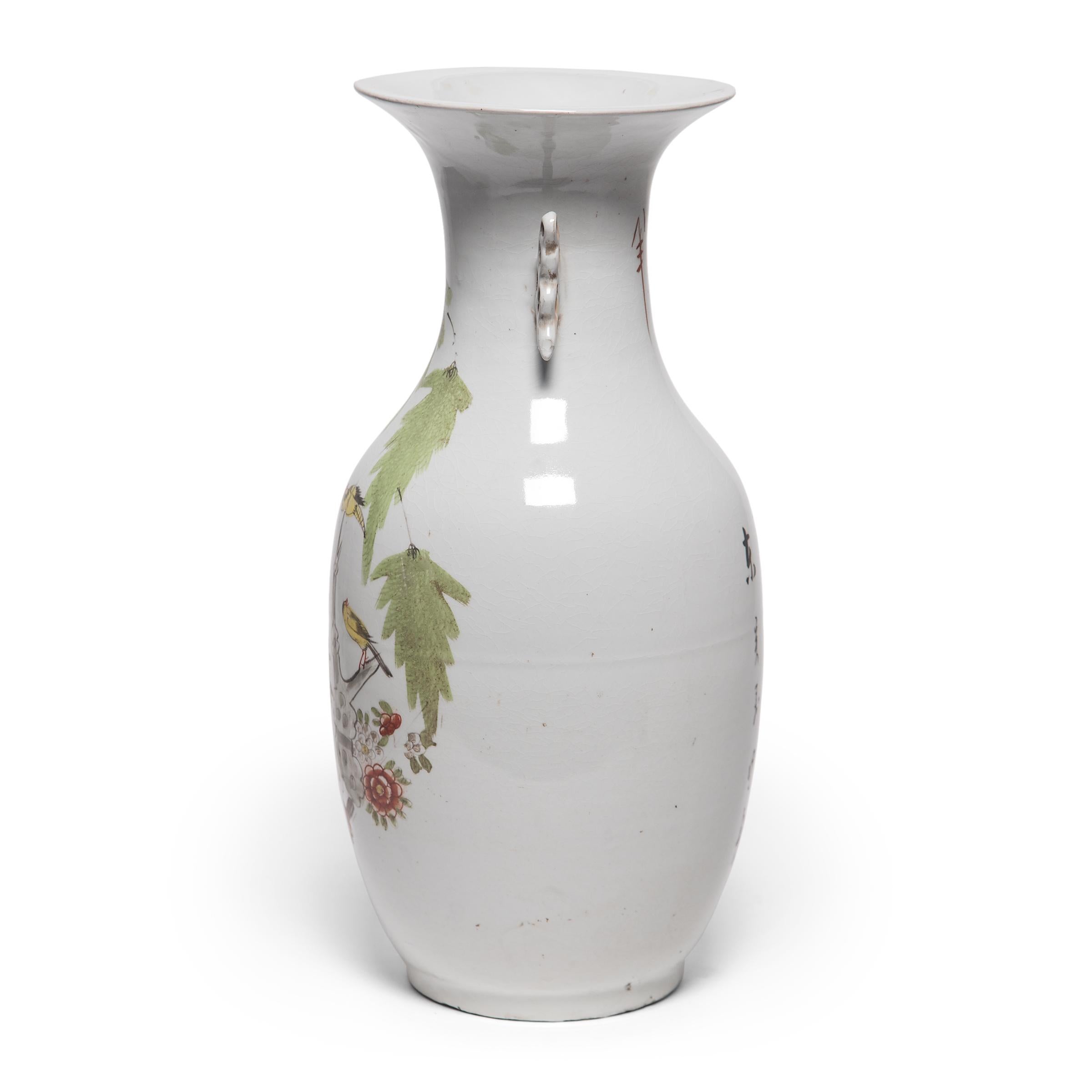 Sculpted in a traditional Chinese phoenix tail vase form, this elegant early 20th century vase is adorned with a scene of magpies flitting between branches covered in cherry blossoms. Regarded as a bird of good omen, magpies bring joy and good