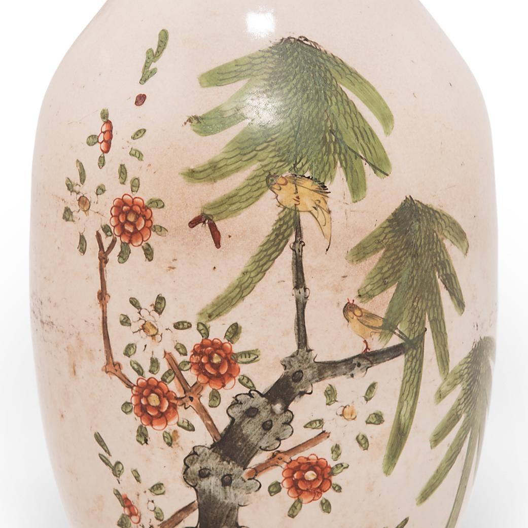 Sculpted in a traditional Chinese phoenix tail vase form, this elegant early 20th century vase is adorned with a scene of magpies flitting between branches covered in cherry blossoms. Regarded as a bird of good omen, magpies bring joy and good