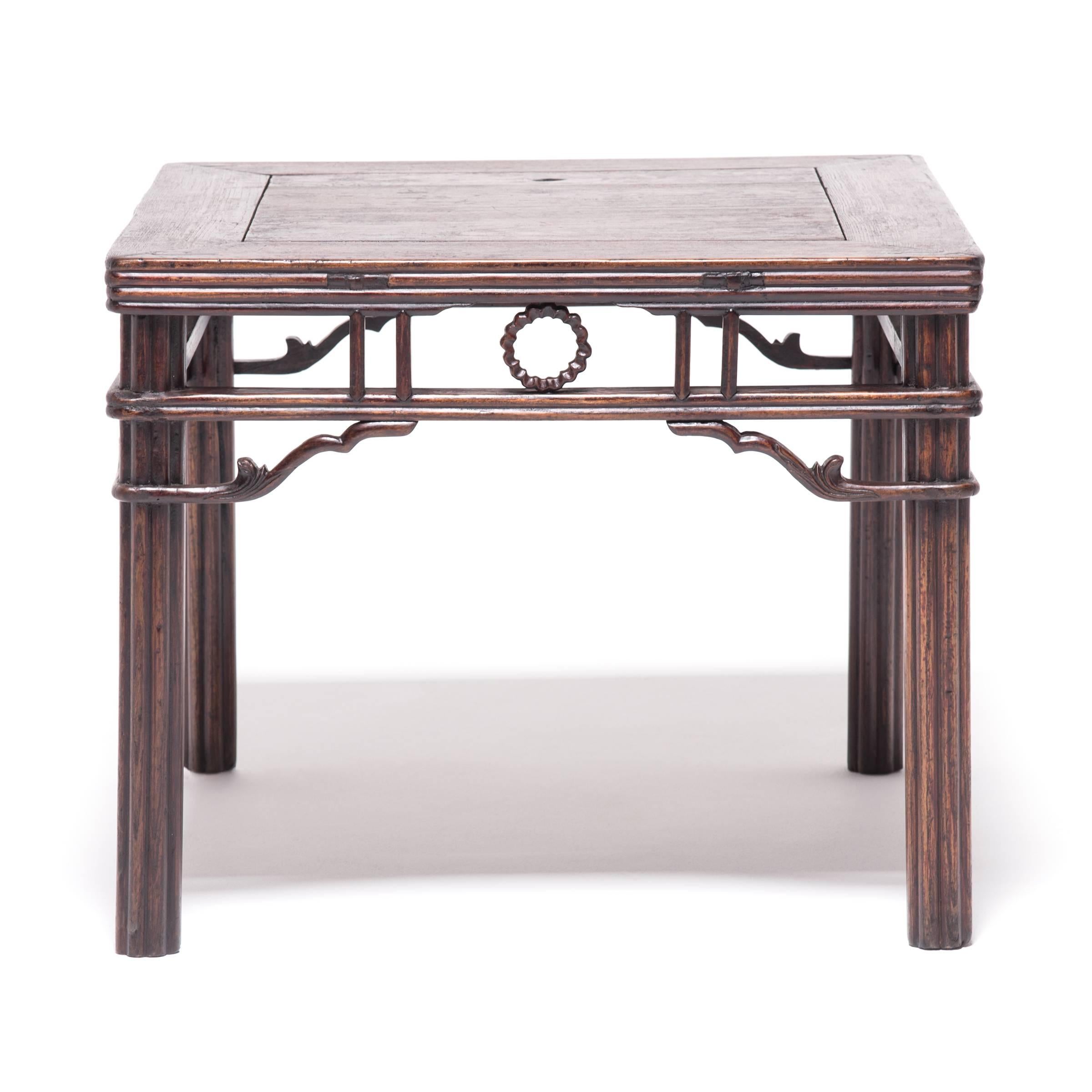 A flourish of curves adds graceful counterpoint to this table’s square profile, accentuated with slim, noodle molding. Each of the legs and the central circular medallion within the apron is thought to be in the shape of a chrysanthemum, a flower