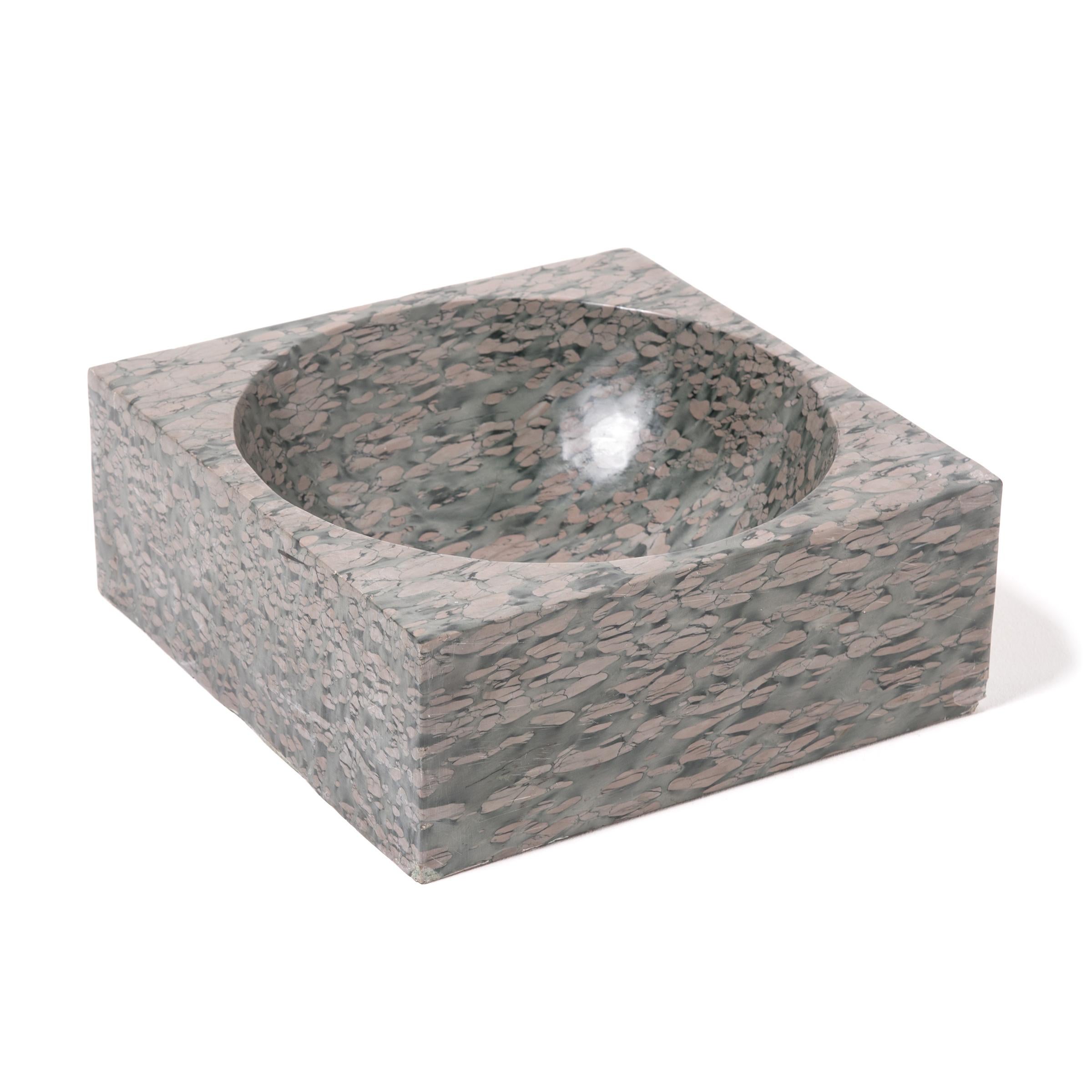 A clean-lined interpretation of an ancient form, this stone basin was hand carved with a rounded interior within finely edged square form. The basin looks meticulously painted, but the mesmerizing pattern of zhenzhu is inherent to the stone, a