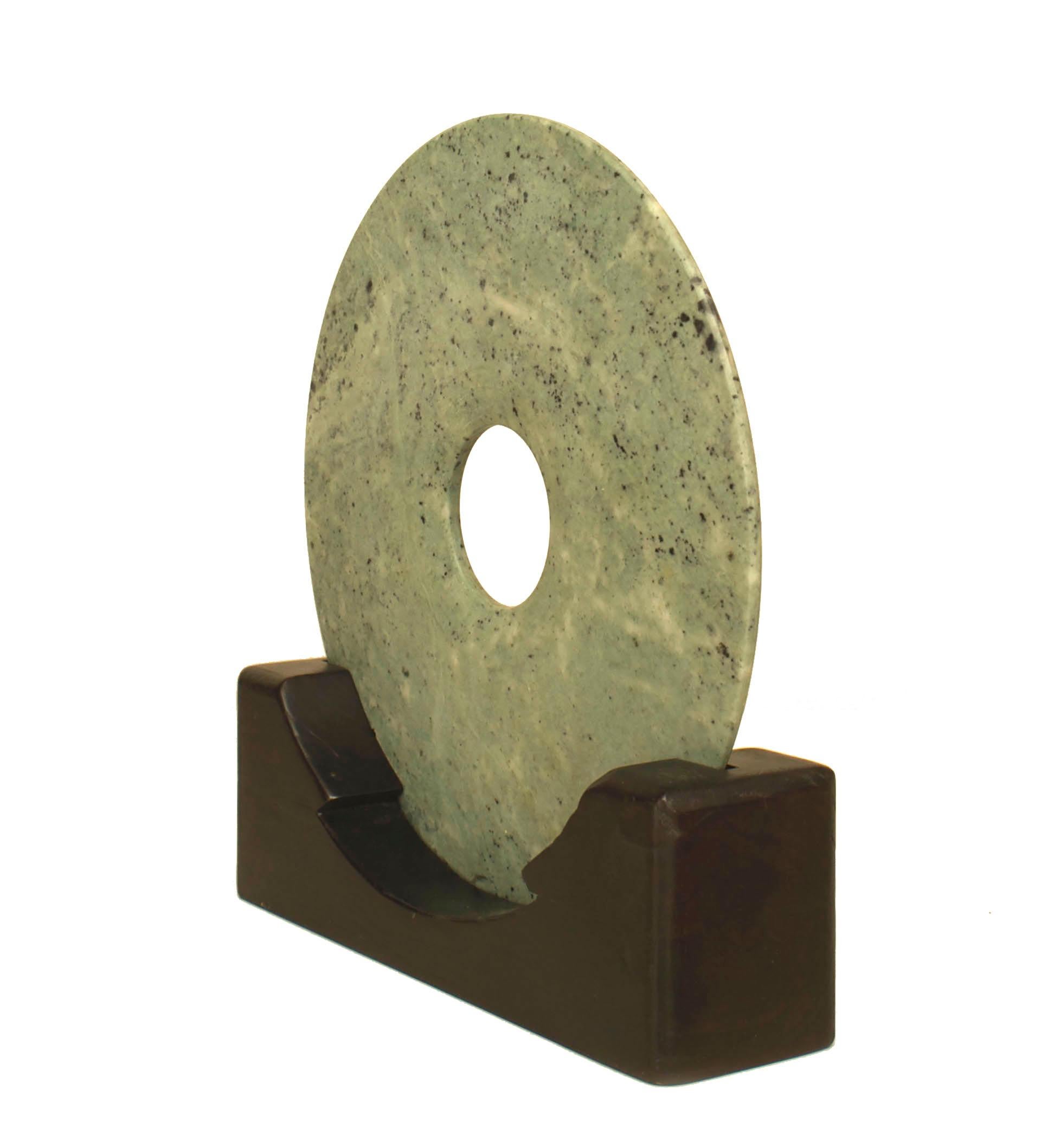 Set of Chinese Jade discs on later wooden stands, of varying sizes, can be sold individually or in groups.

Measurement represents the largest disc