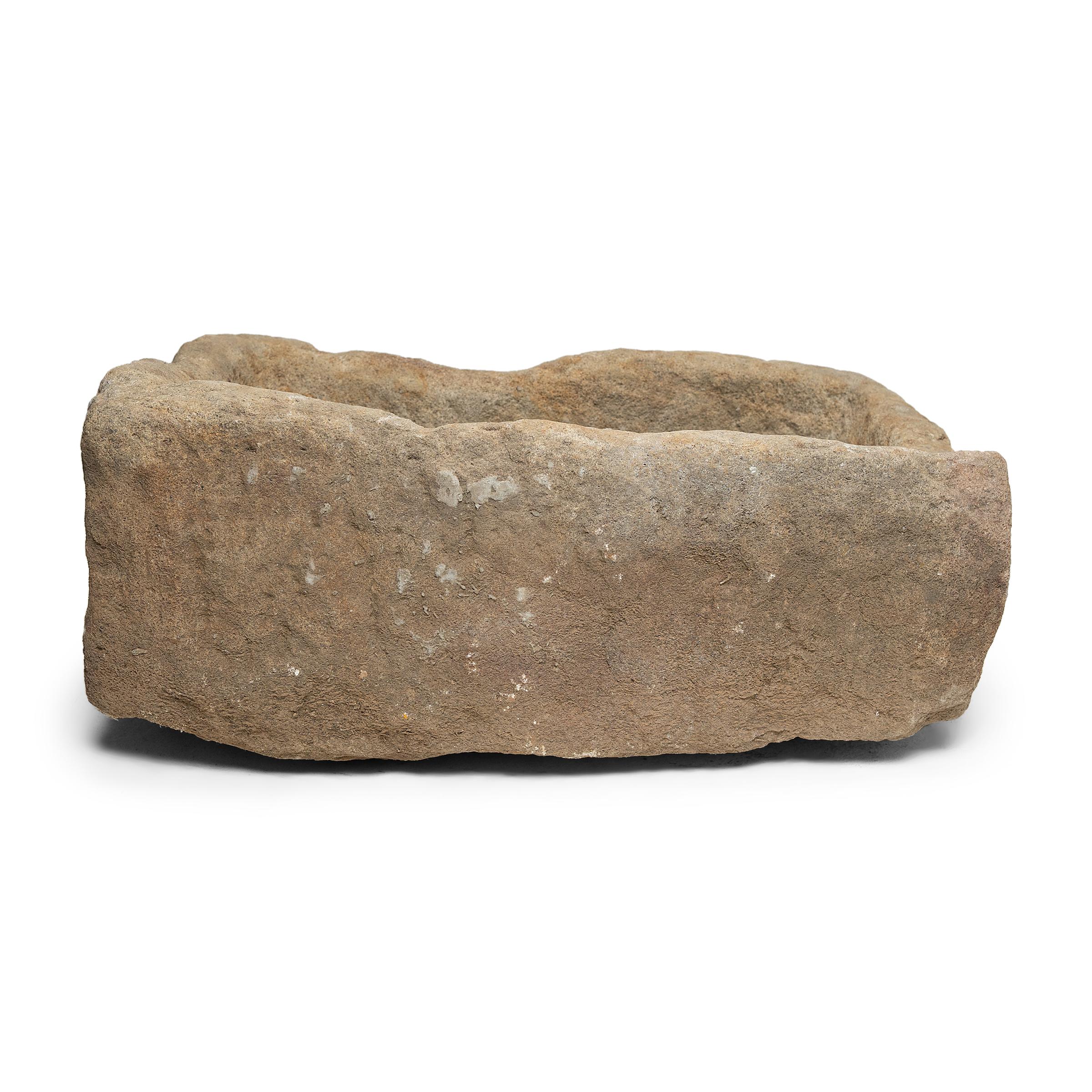 Once used on a Provincial Chinese farm to hold water or animal feed, this turn-of-the-century stone trough is celebrated today for its organic form and rustic authenticity. hand carved from solid limestone, the trough's chiseled surface has