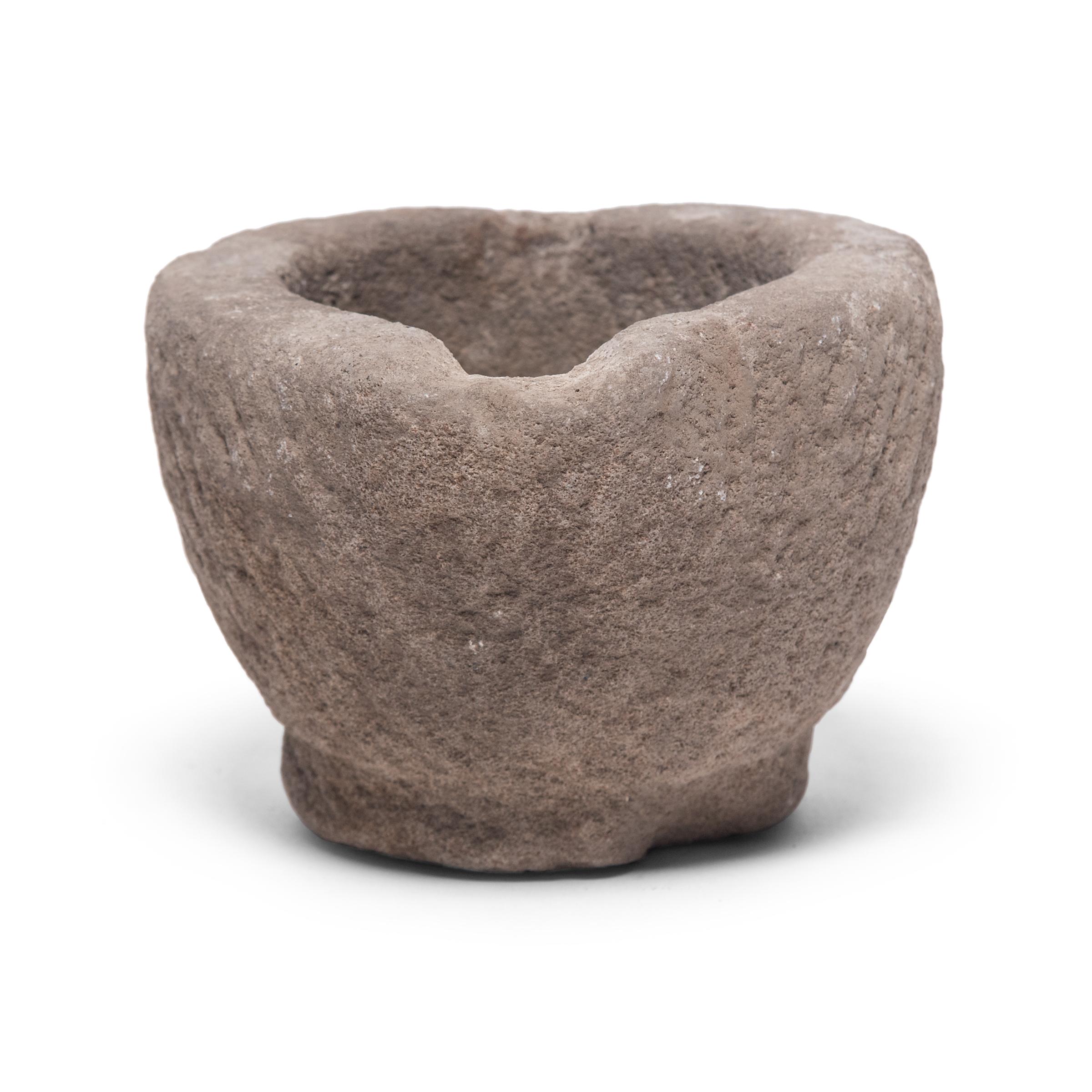 Hand carved from a single block of limestone, this round stone vessel is an early 20th century mortar once used daily in a Provincial kitchen to grind herbs, spices, and other foods. Used as a decorative vessel or tabletop planter, the mortar's