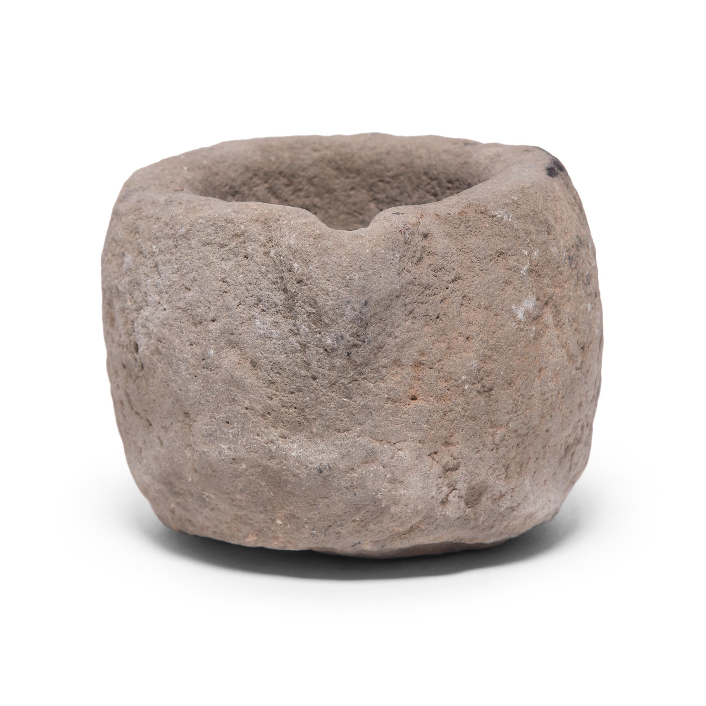 Hand carved from a single block of limestone, this round stone vessel is an early 20th century mortar once used daily in a Provincial kitchen to grind herbs, spices, and other foods. Used as a decorative vessel or tabletop planter, the mortar's