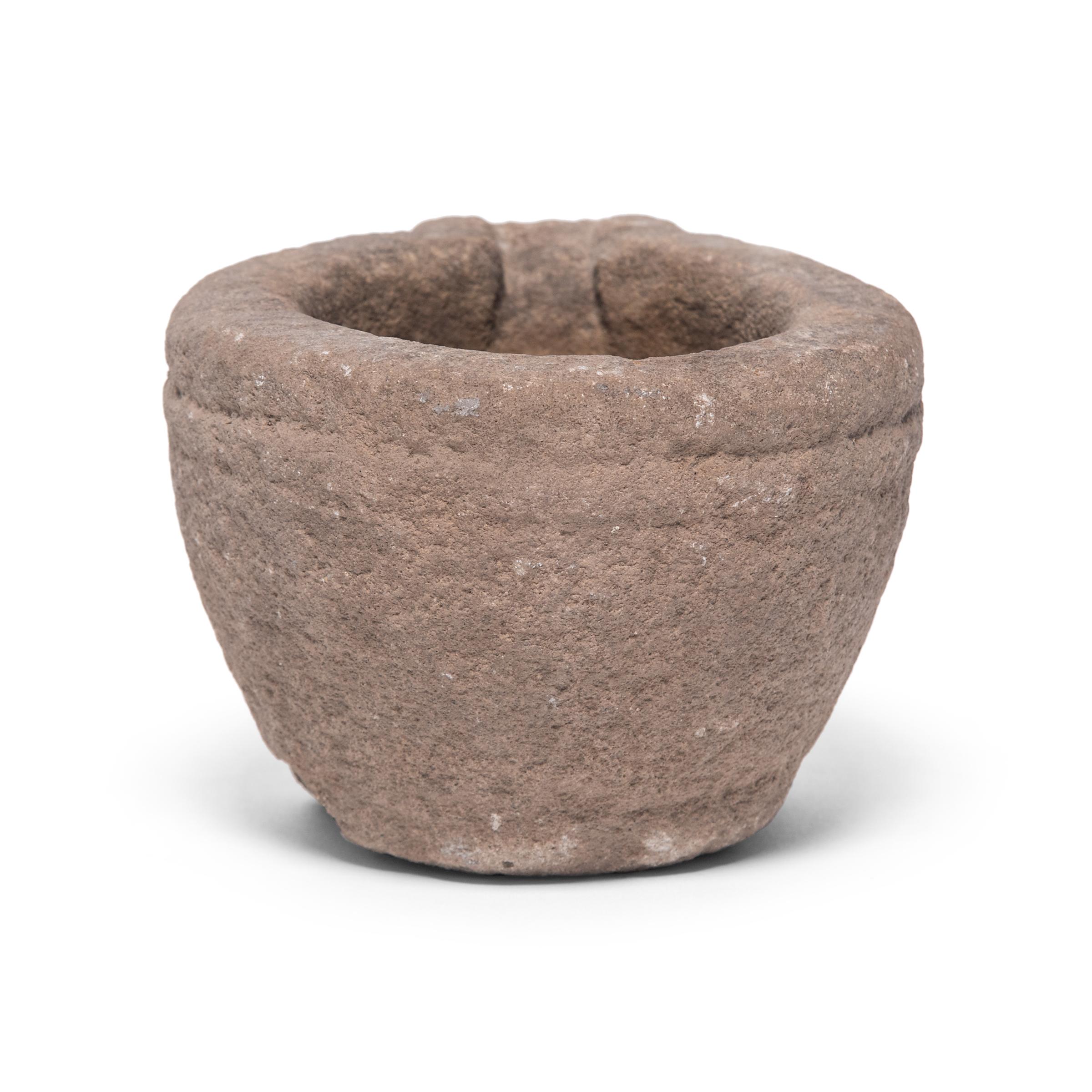 Hand carved from a single block of limestone, this round stone vessel is an early 20th century mortar once used daily in a Provincial kitchen to grind herbs, spices, and other foods. Used as a decorative vessel or tabletop planter, the mortar's