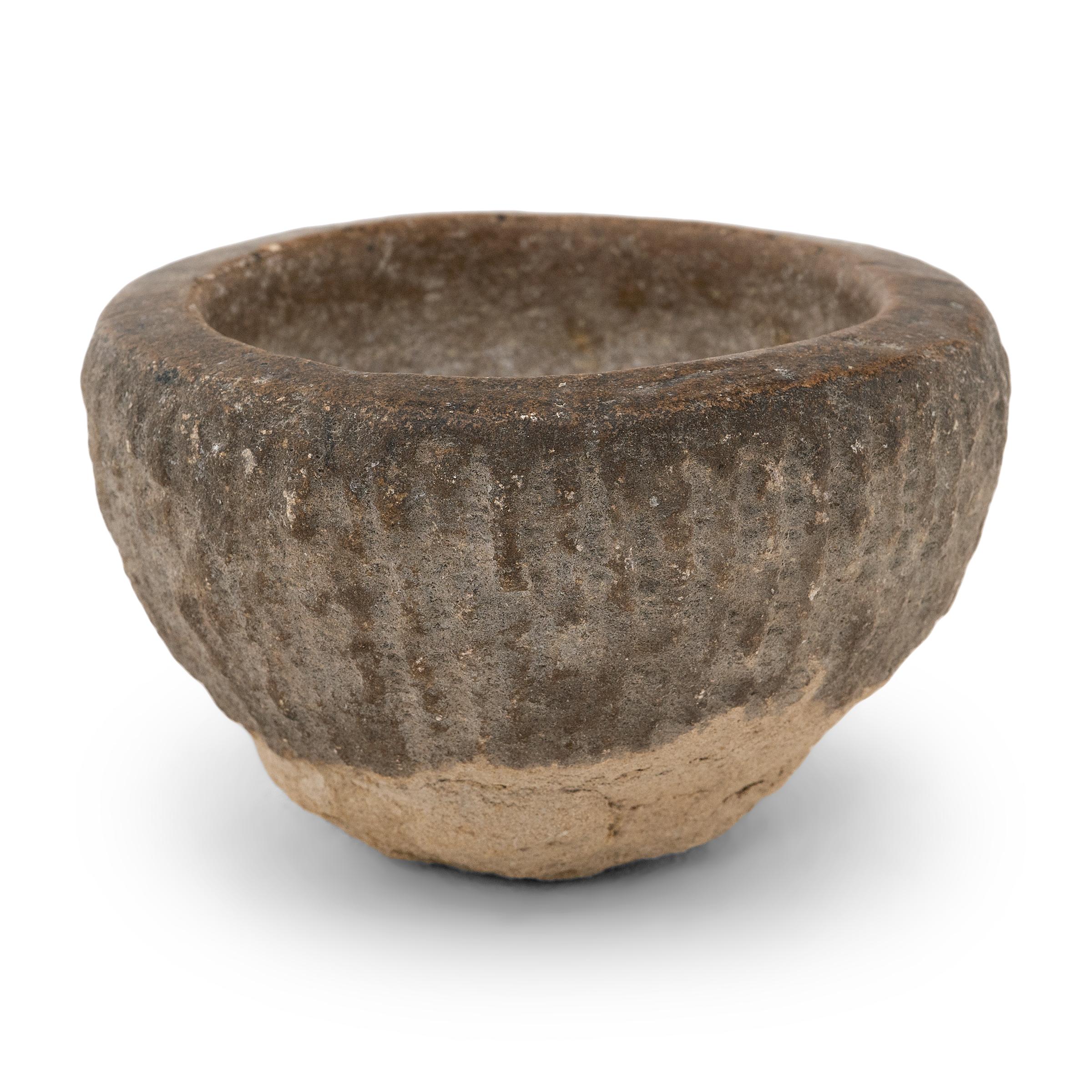 Carved from a single block of limestone, this stone vessel is an early 19th century mortar once used to grind spices, herbs, and other condiments. The hand chiseled, rustic exterior is worn gorgeously with age while the interior is smooth from daily