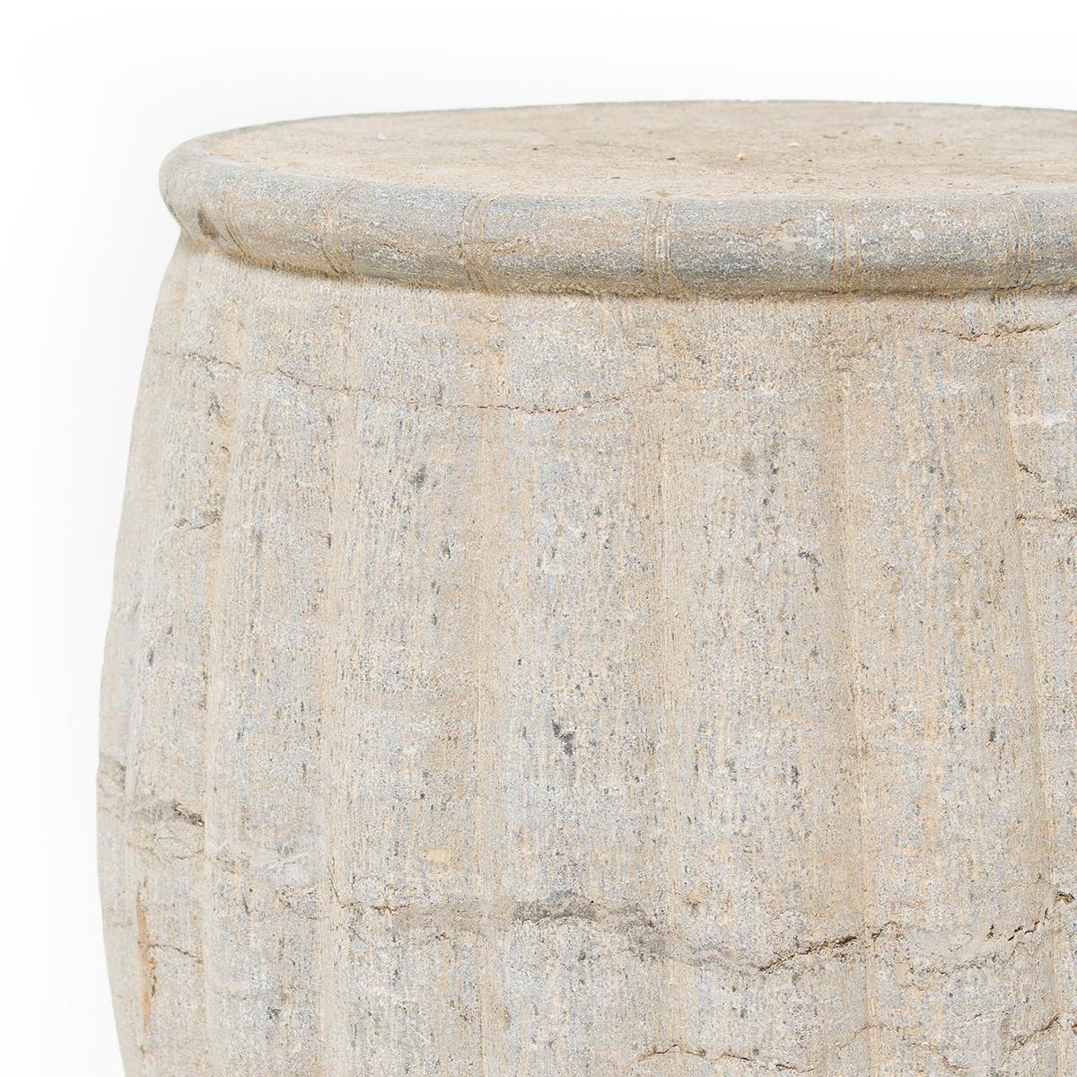 This large stone drum stool was carved from a solid block of limestone with a traditional melon design. Traditionally used as a place to rest one’s feet, stone drums are ideal as side tables or garden seating.

Multiple drums