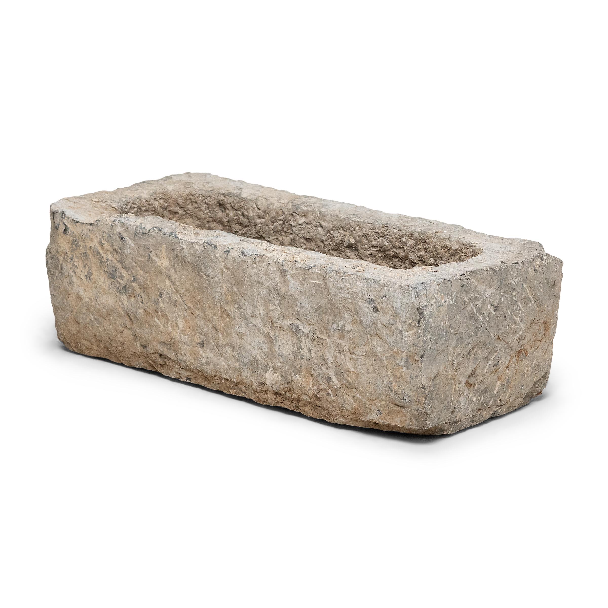 Once used on a provincial Chinese farm to hold water or animal feed, this early 20th-century stone trough is celebrated today for its organic form and rustic authenticity. The trough is hand-carved from solid limestone with a rectangular form,