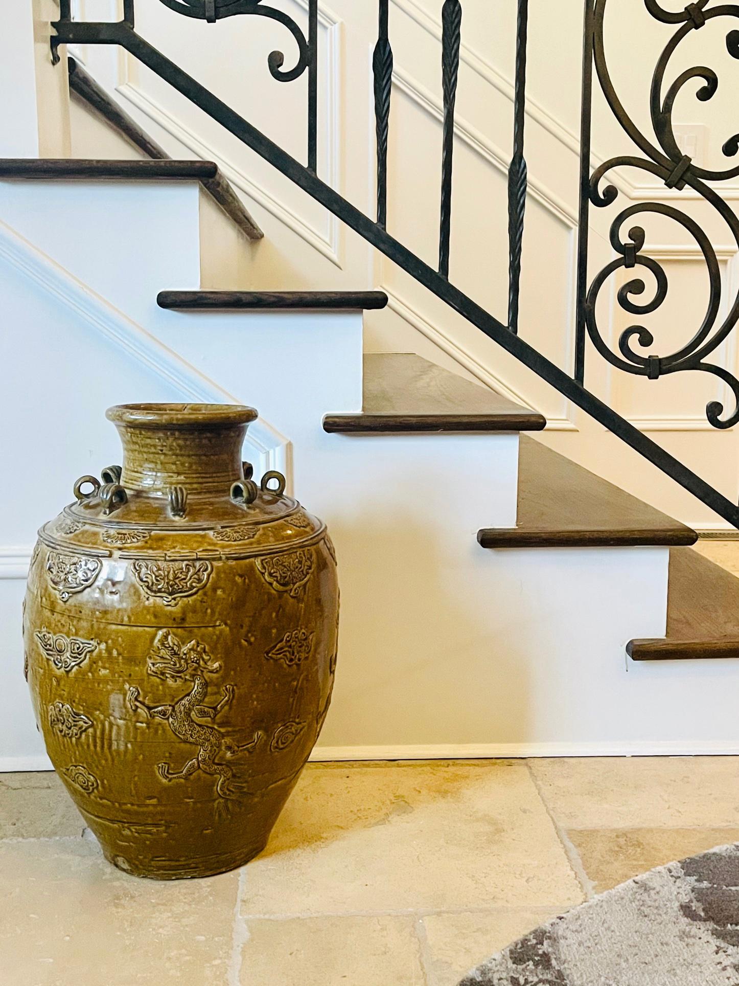 Heavily potted in a robust baluster form, this Chinese stoneware storage jar is covered with a thick yellow glaze. With a functional purpose, the wide shoulder was equipped with a circle of loops which were used to fasten the lid to the body. These