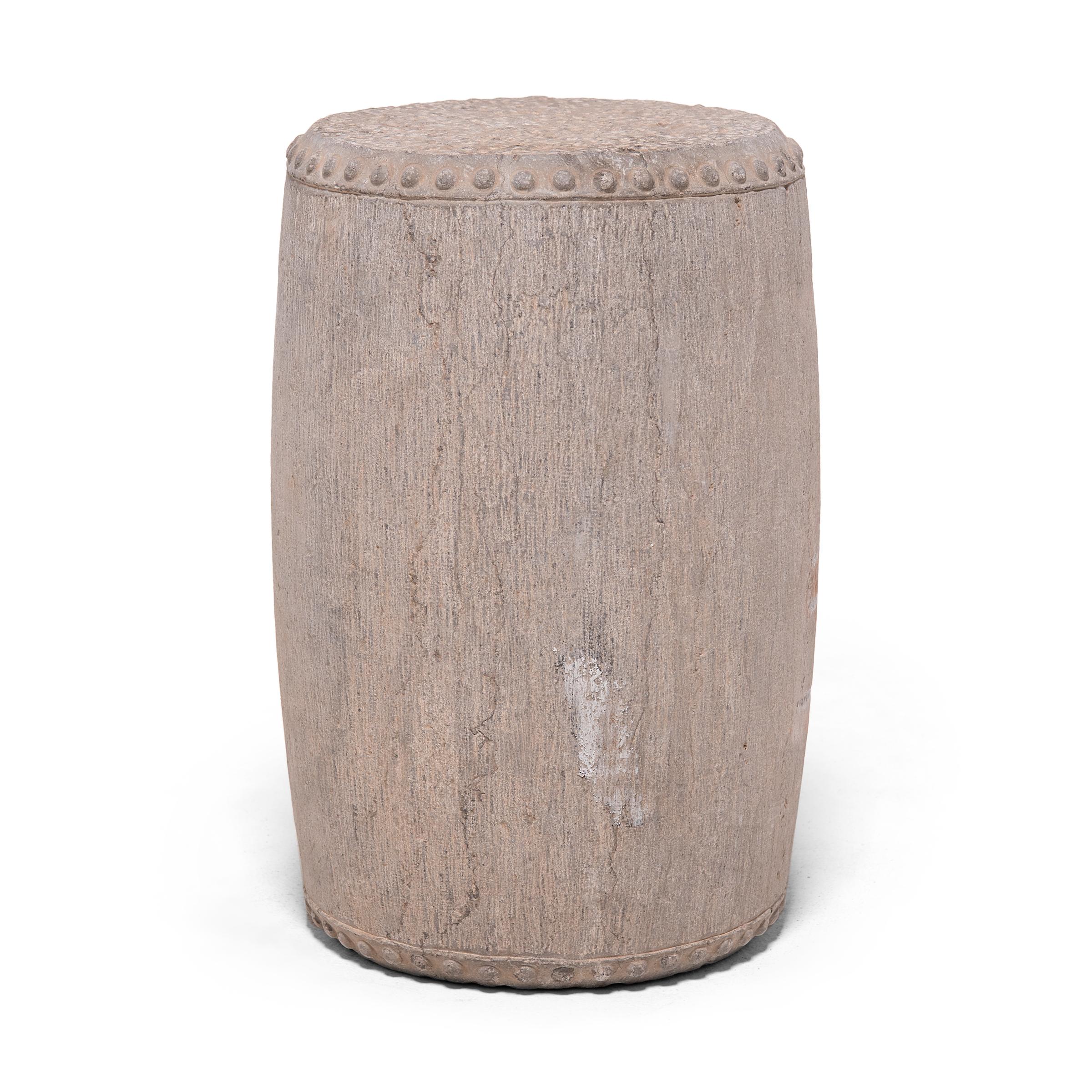 This elegant garden stool was carved from a solid block of limestone by artisans in the Shanxi region of China. Drum-form stools such as this were traditionally used in gardens and outdoor pavilions where upper class scholars read, wrote, discussed