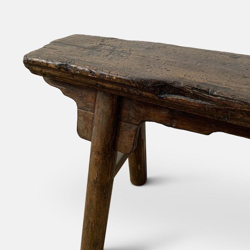 Chinese style gate bench

The single-plank top carved with a beveled edge, above plain aprons and curved spandrels, the whole raised on splayed legs joined by double stretchers. Believed to date from 19th century.
  