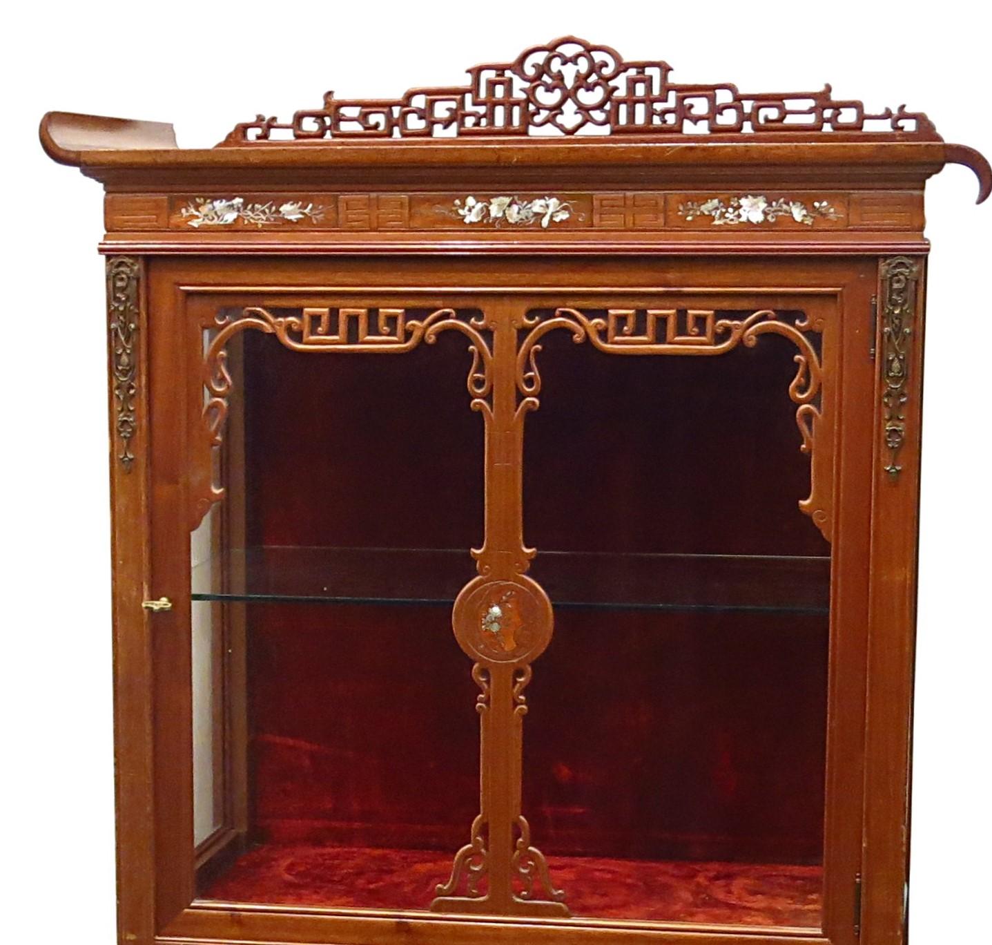 Very fine Chinese-style mahogany display case, opening with a door located on its upper part and two doors on its lower part. Provided with a glass shelf in order to display collector's items. Upper part is inlaid with mother of pearl designed in a