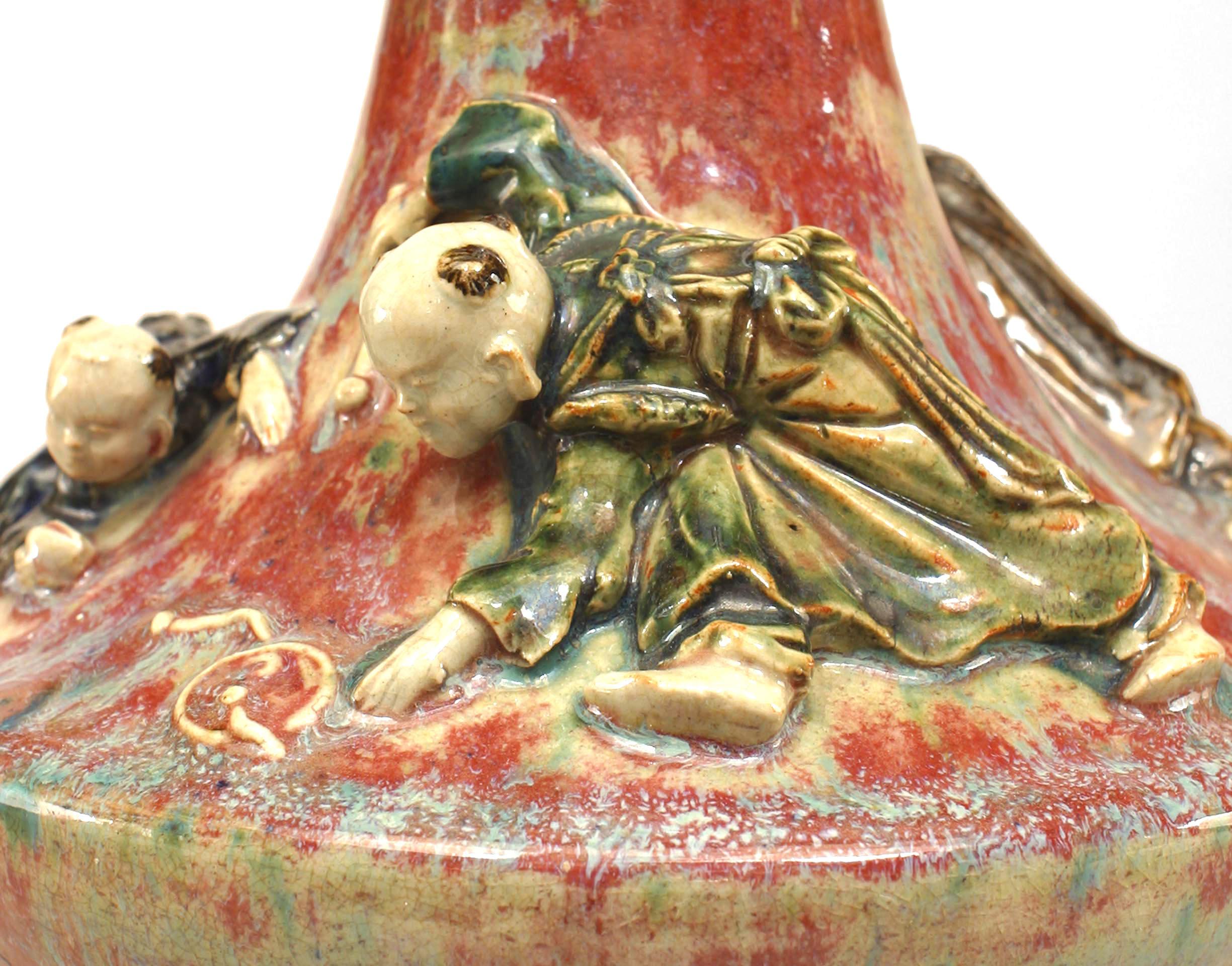 Asian Chinese style (20th cent) stoneware vase with multi-colored glaze and 3 figures in high relief.
     