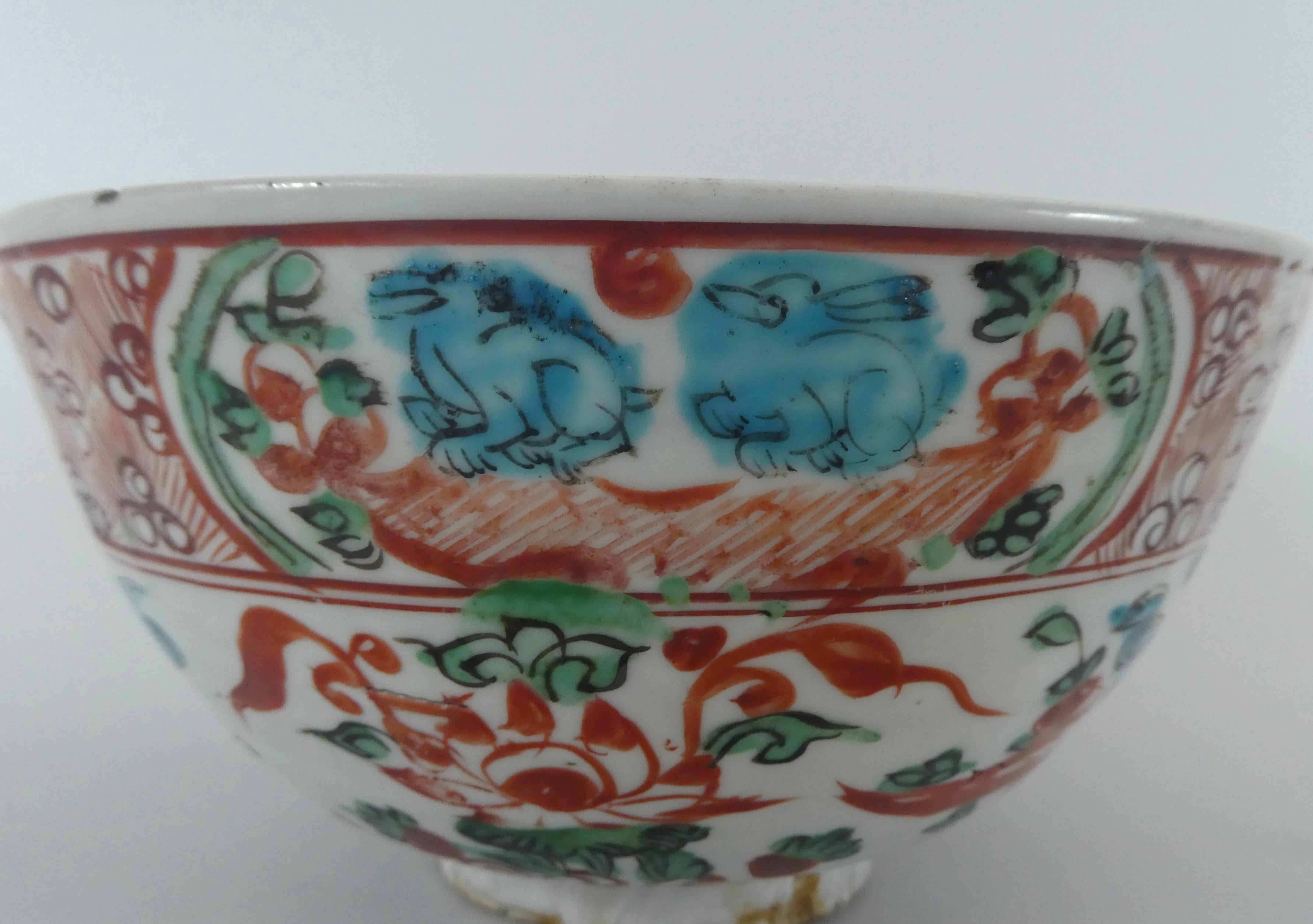 Chinese Swatow porcelain large bowl, circa 1600, Ming Dynasty. The deep sided bowl, exuberantly painted in polychrome enamels, with birds flying amongst flowering plants. The border with panels of rabbits, fish, ducks and birds, outlined in black,