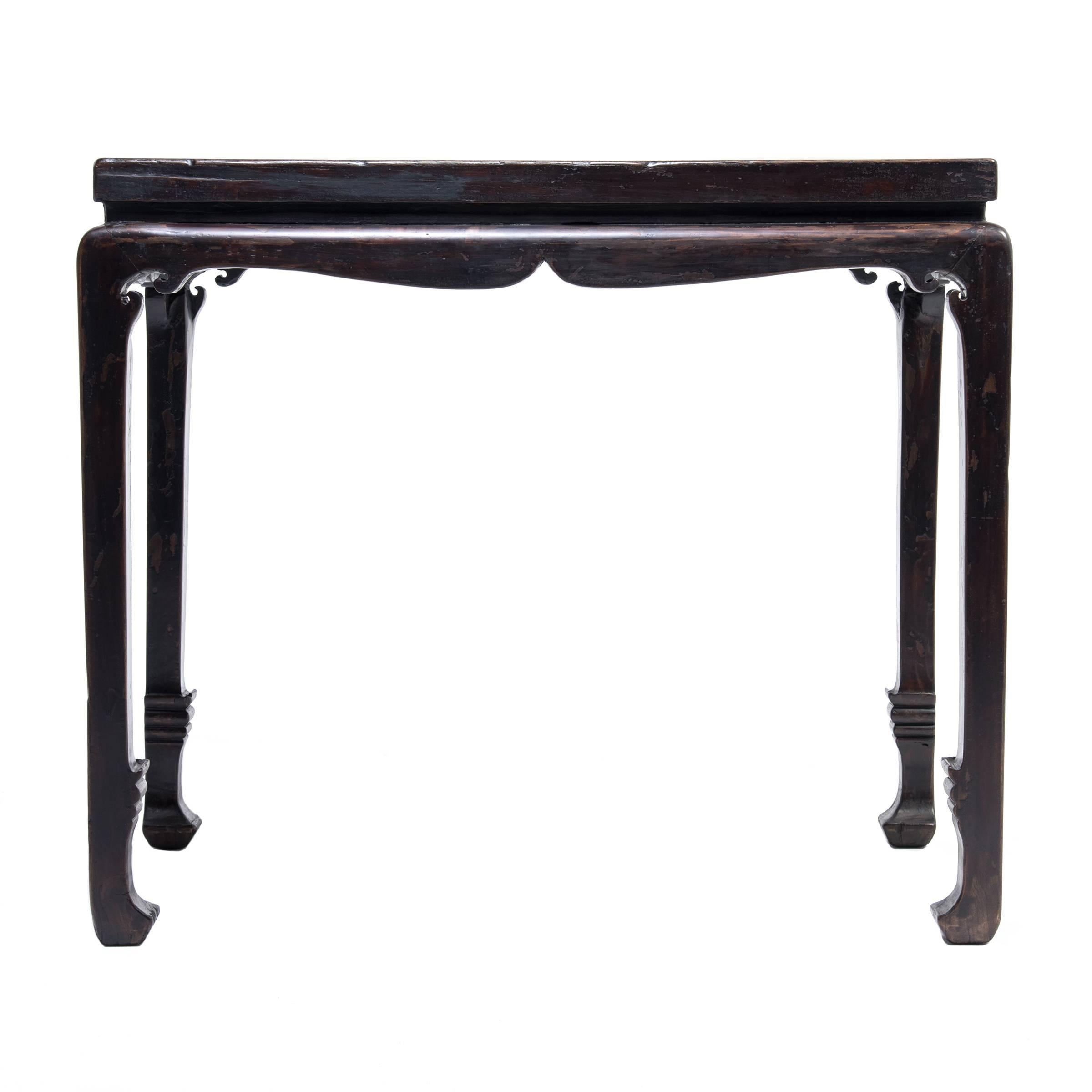 This 19th century table is styled with lyrical lines and classical proportions. It is easily identified by its arched and curved apron and the beautifully balanced abstract sword shape of its lower legs and feet. The round shoulders beneath the