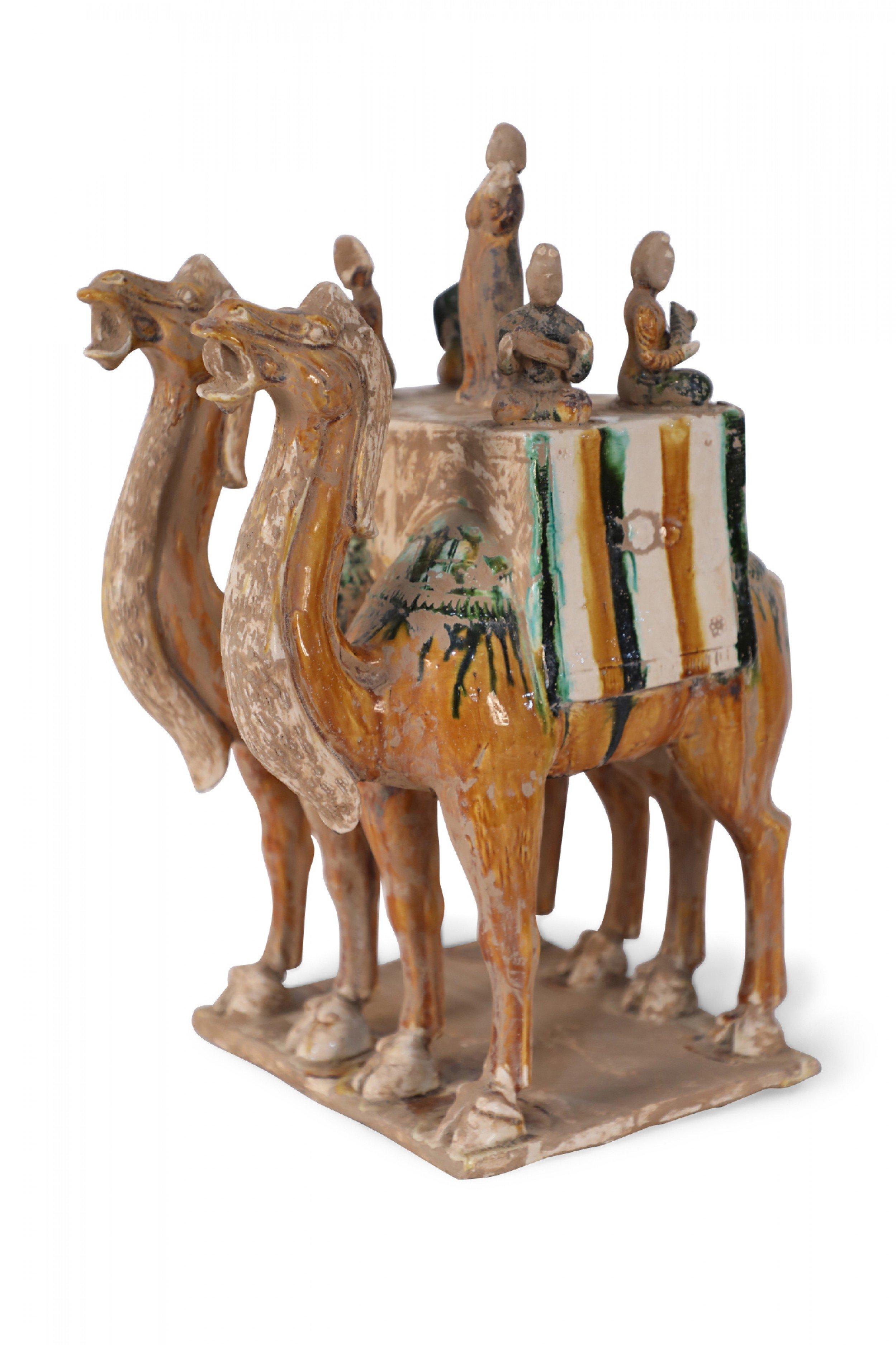 Antique Chinese Tang Dynasty-style terra cotta tomb figure of two camels carrying a band of five musicians - four seated with instruments, and one central figure standing to sing. The figure is crafted with the Tang Dynasty's traditional tri-color