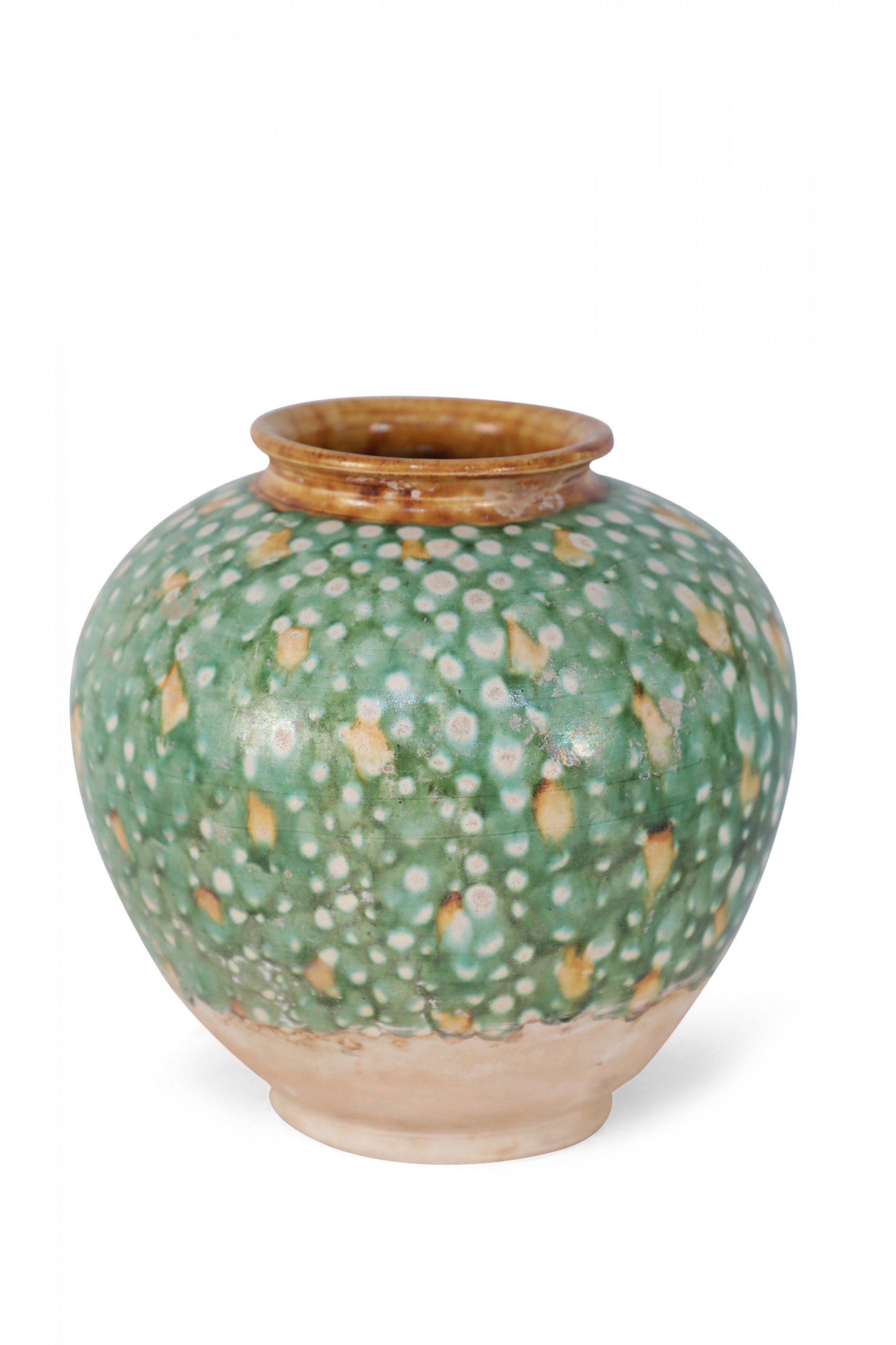Antique Chinese Tang Dynasty-style vase crafted with the traditional tri-color glaze, or Sancai, utilizing brown, green and off-white, and with a glazed ochre-color opening.