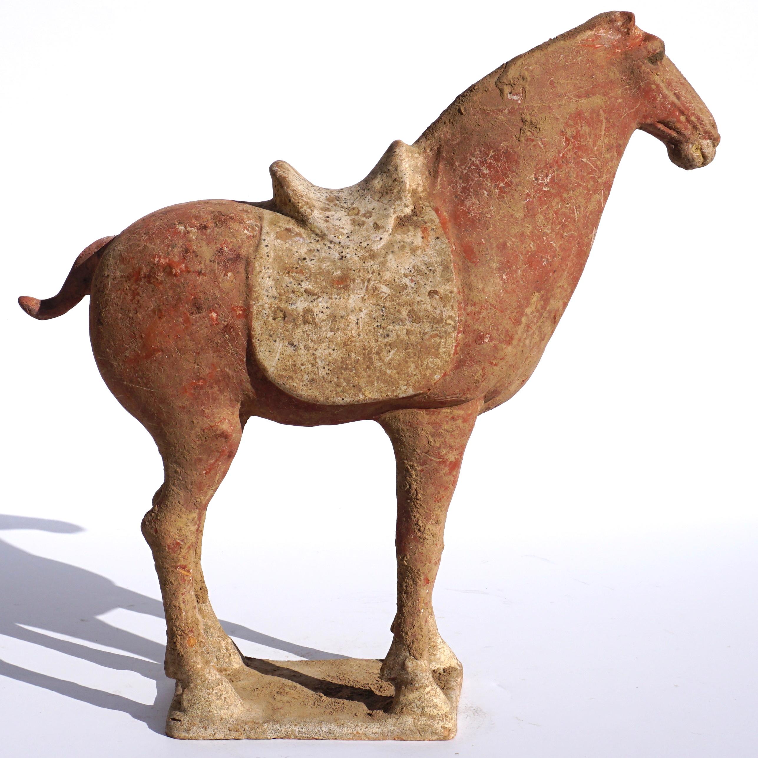 A powerfully proportioned Mingqi tomb pottery horse with traces of red polychrome colors. Absolutely wonderful energy with original red polychrome paint which alludes to famous triumphant battles where horses were painted red in symbolic gestures.