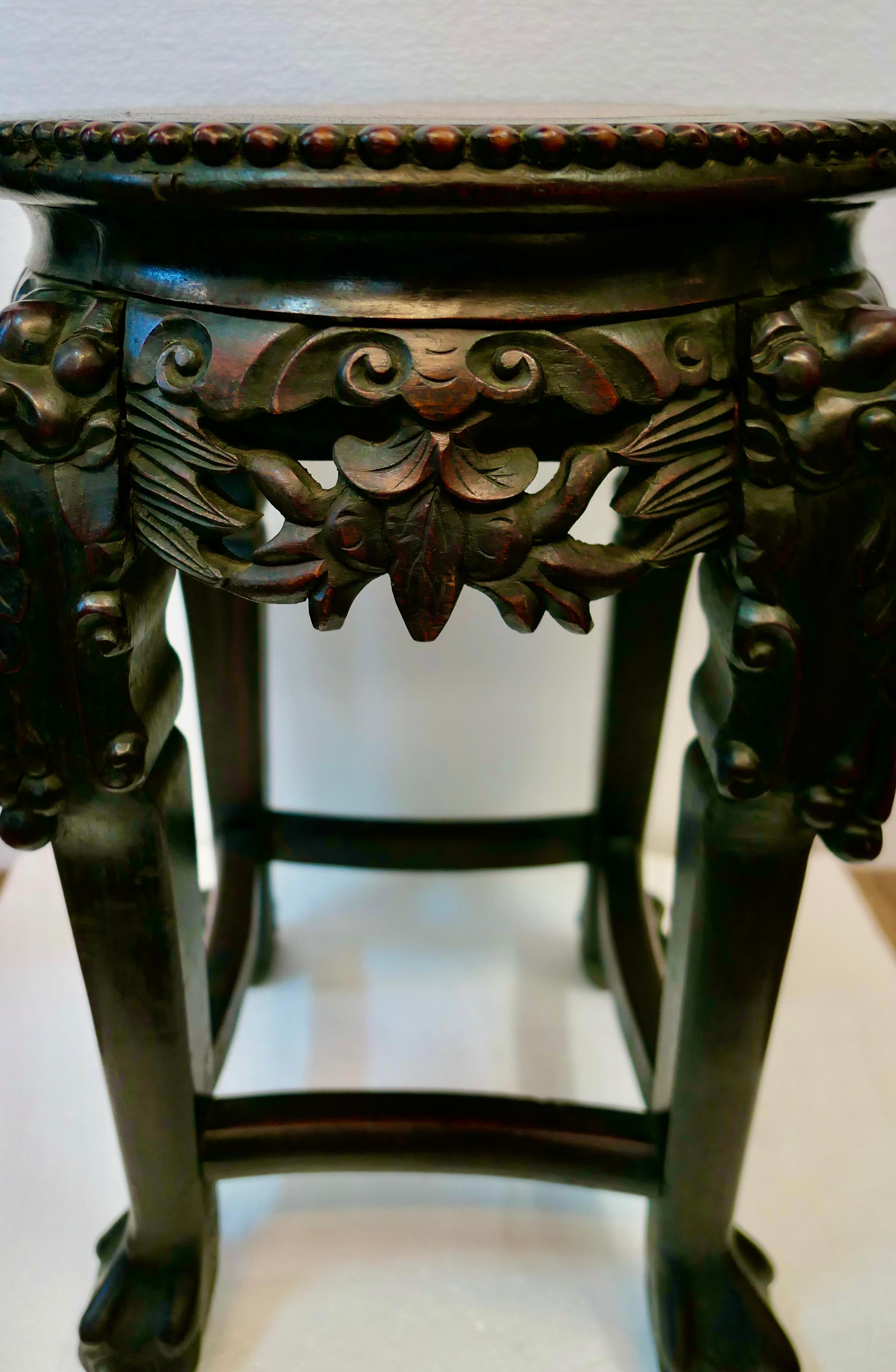 This antique hand crafted Chinese teak table dates from the late 1890’s & has a wonderful “old world” appearance. It has intricate carved panels accented between carved deity inspired legs with ball & claw feet. The top of the table has a wonderful
