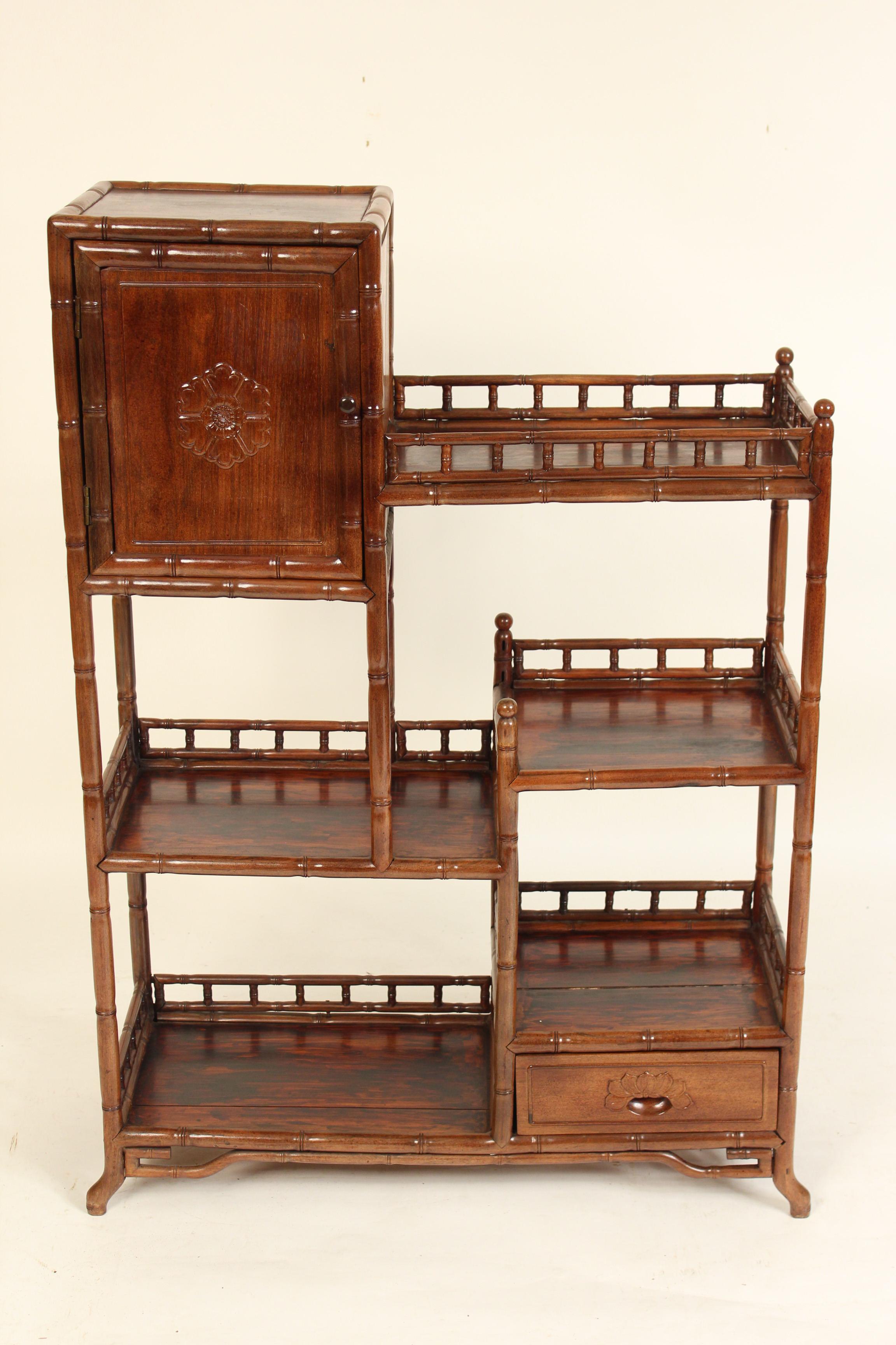 Chinese teak wood étagère / bookcase with cabinet door, circa 1930.