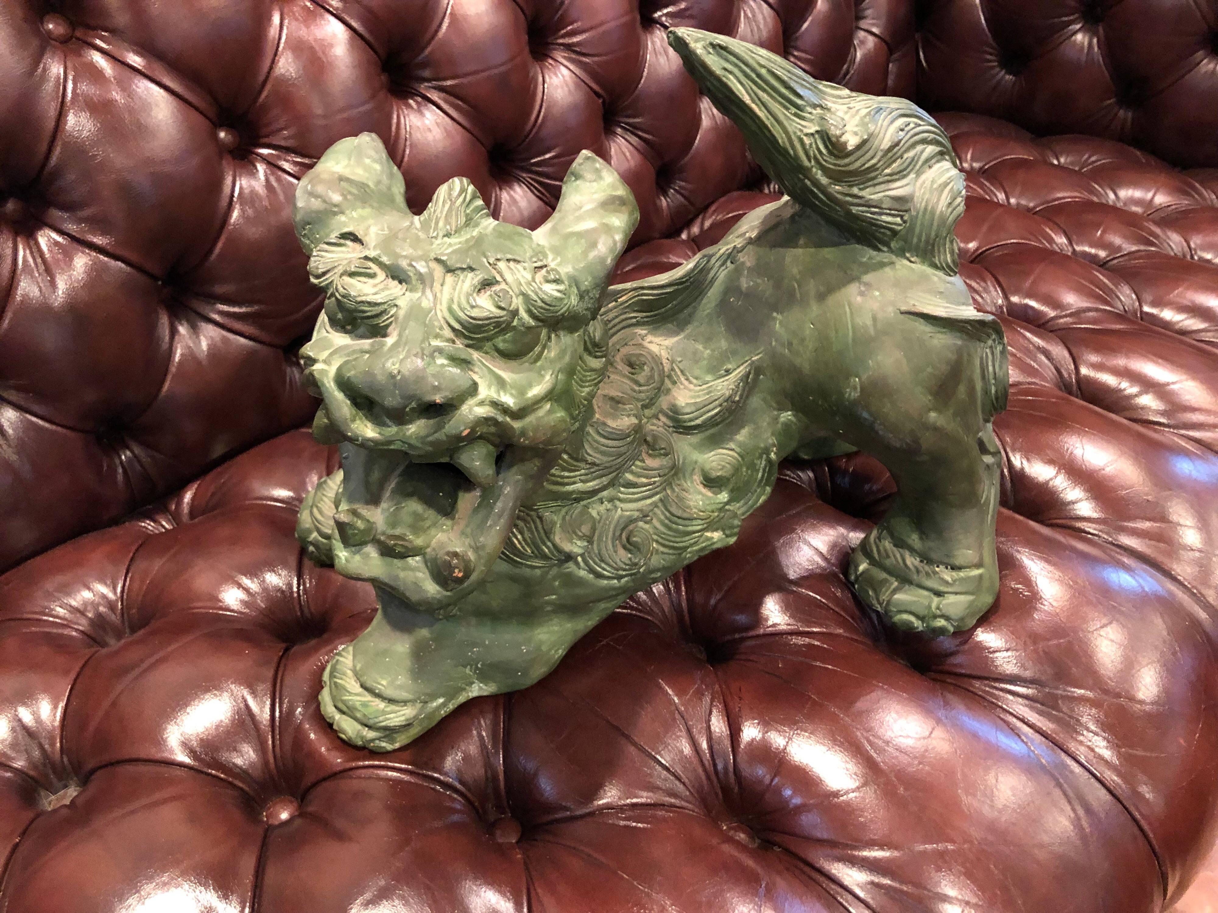 Chinese terracotta foo dog. Intricate detail to this statue that is in a matte olive green wash. No signature found. Some small chips and repaint.