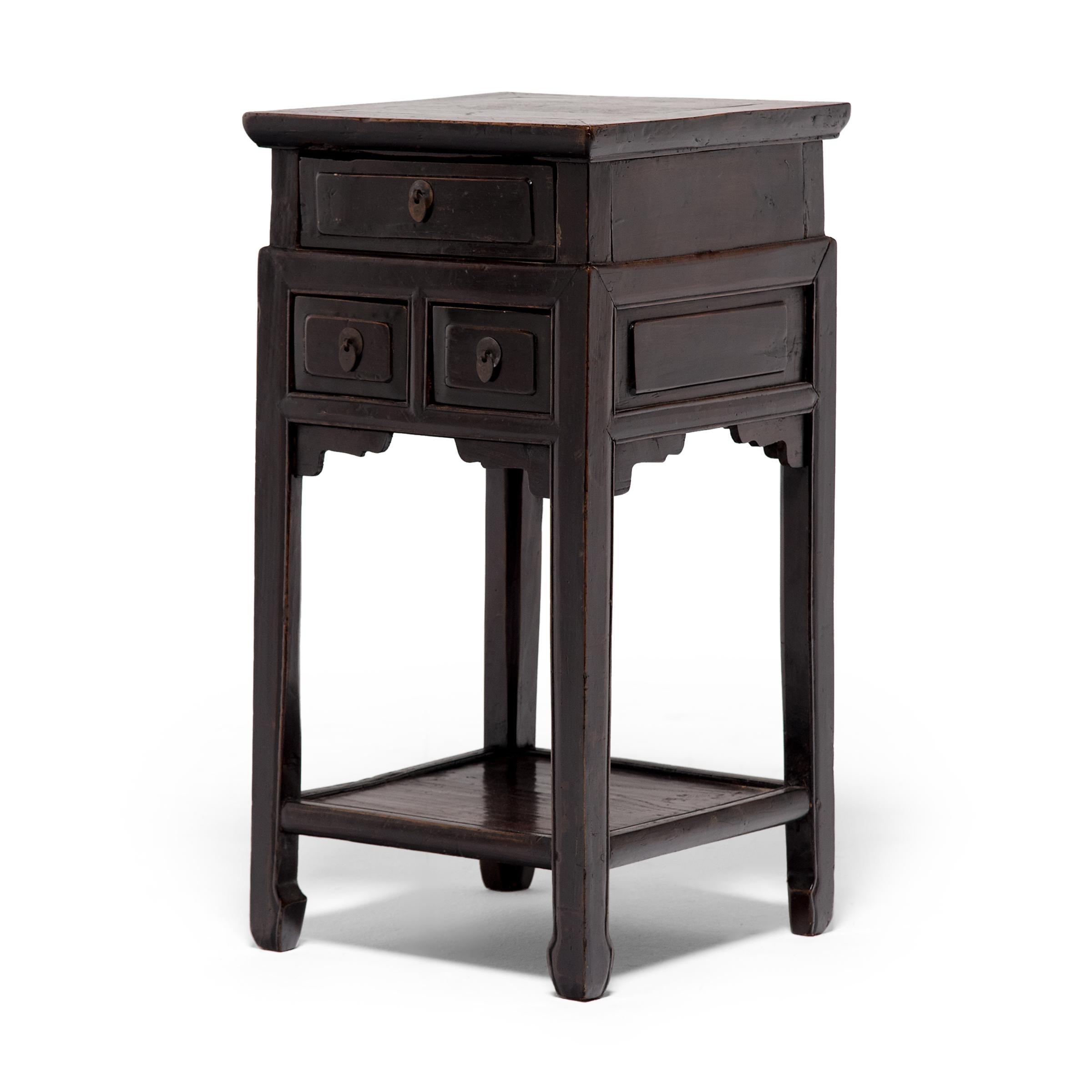 Popularized during the Ming dynasty (1368-1644), tall display tables such as this were used to display precious objects, serve tea, or elevate burning incense. This square example dates to the mid-19th century and features a lower shelf and three