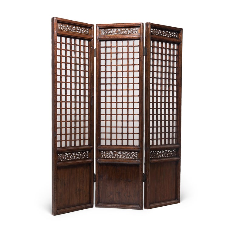 A hallmark of Qing-dynasty domestic architecture, tall lattice panels such as these were used in provincial courtyard homes to allow light and air into a room whilst maintaining privacy. Linked by alternating hinges, lattice panels become a