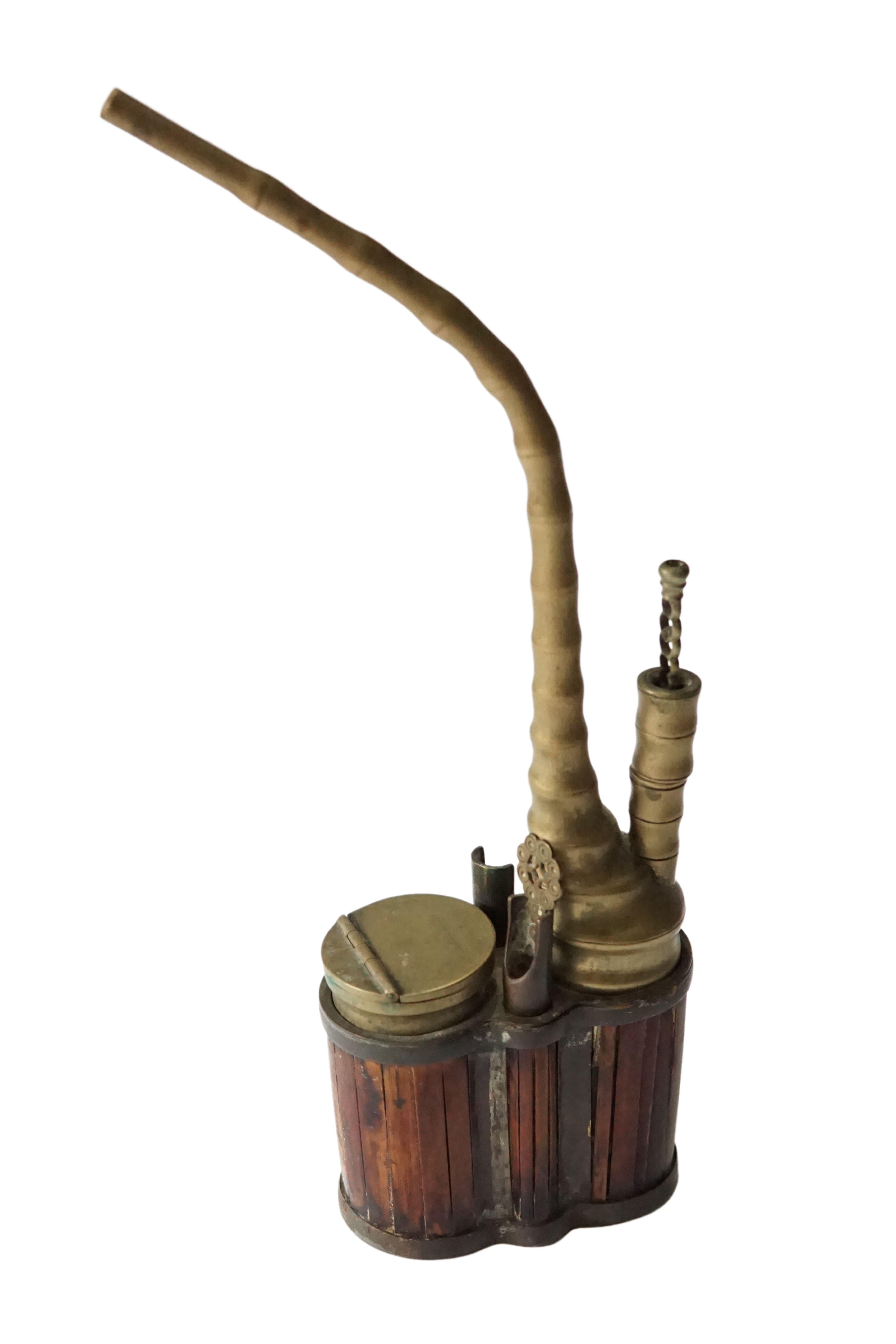 Despite common belief that water pipes such as these were used to smoke opium, water pipes such as these were more commonly used for smoking Tobacco. The hinged compartment is where the tobacco would be placed for smoking. This pipe features Chinese