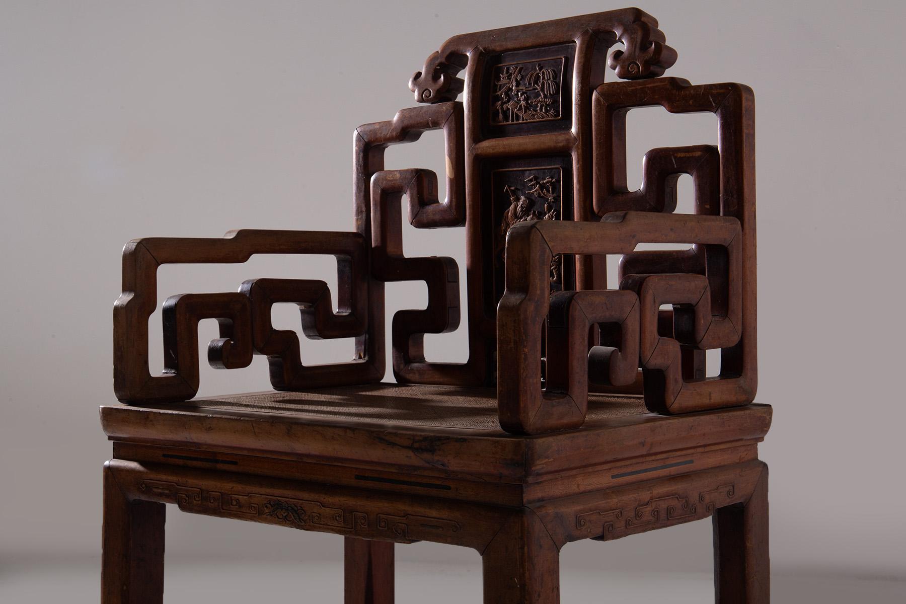 This splendid Chinese chair, crafted in the Qing style, captivates attention with its exceptional craftsmanship and intricate design that embodies a deep connection to Eastern cultural tradition. Made from fine wood, its structure is solid and