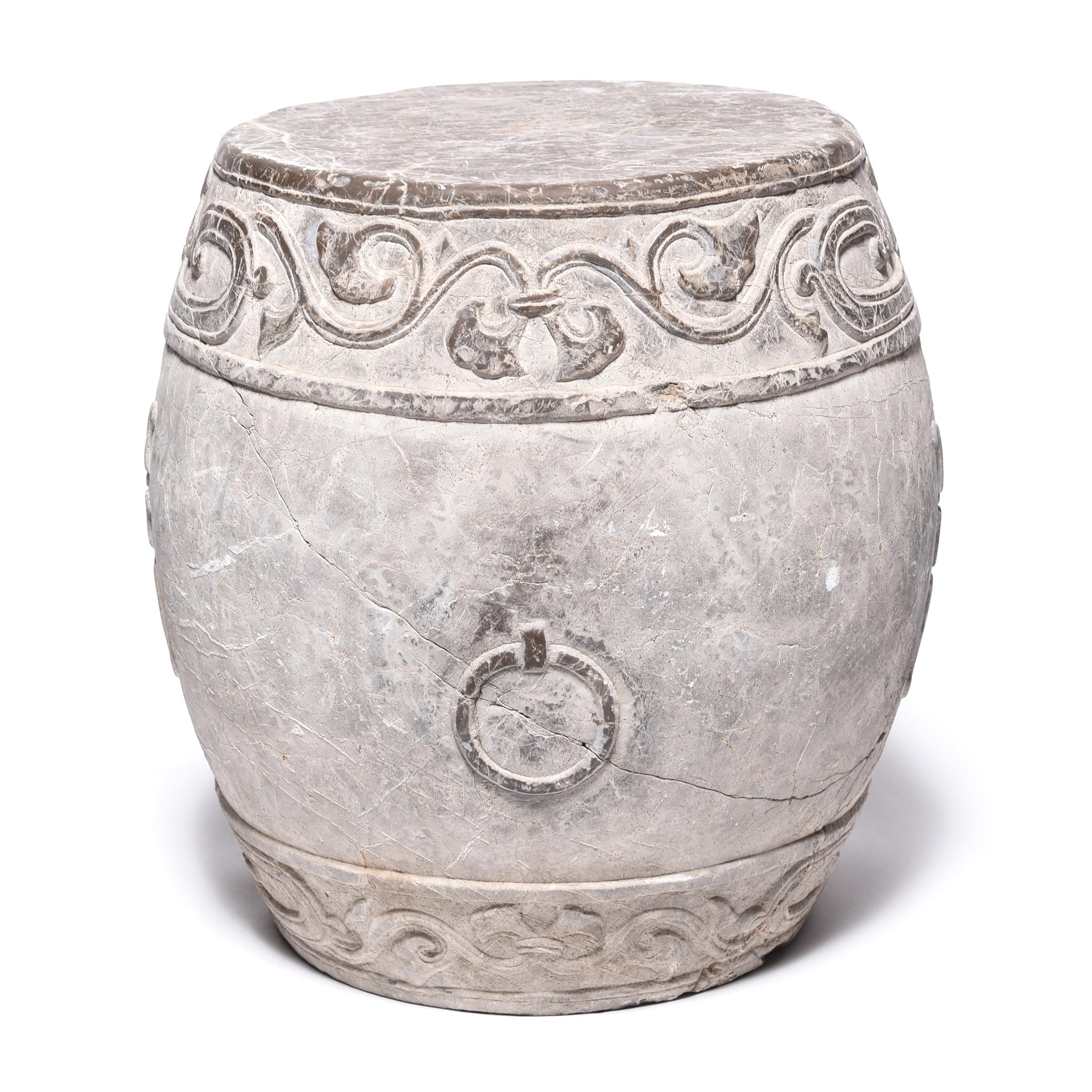 Made in Shanxi province, this venerable drum stone was hand carved with a trailing vine motif and an auspicious “fu” character representing prosperity. Polishing brings out the intricate relief carving and smooths the top, making this drum a lovely