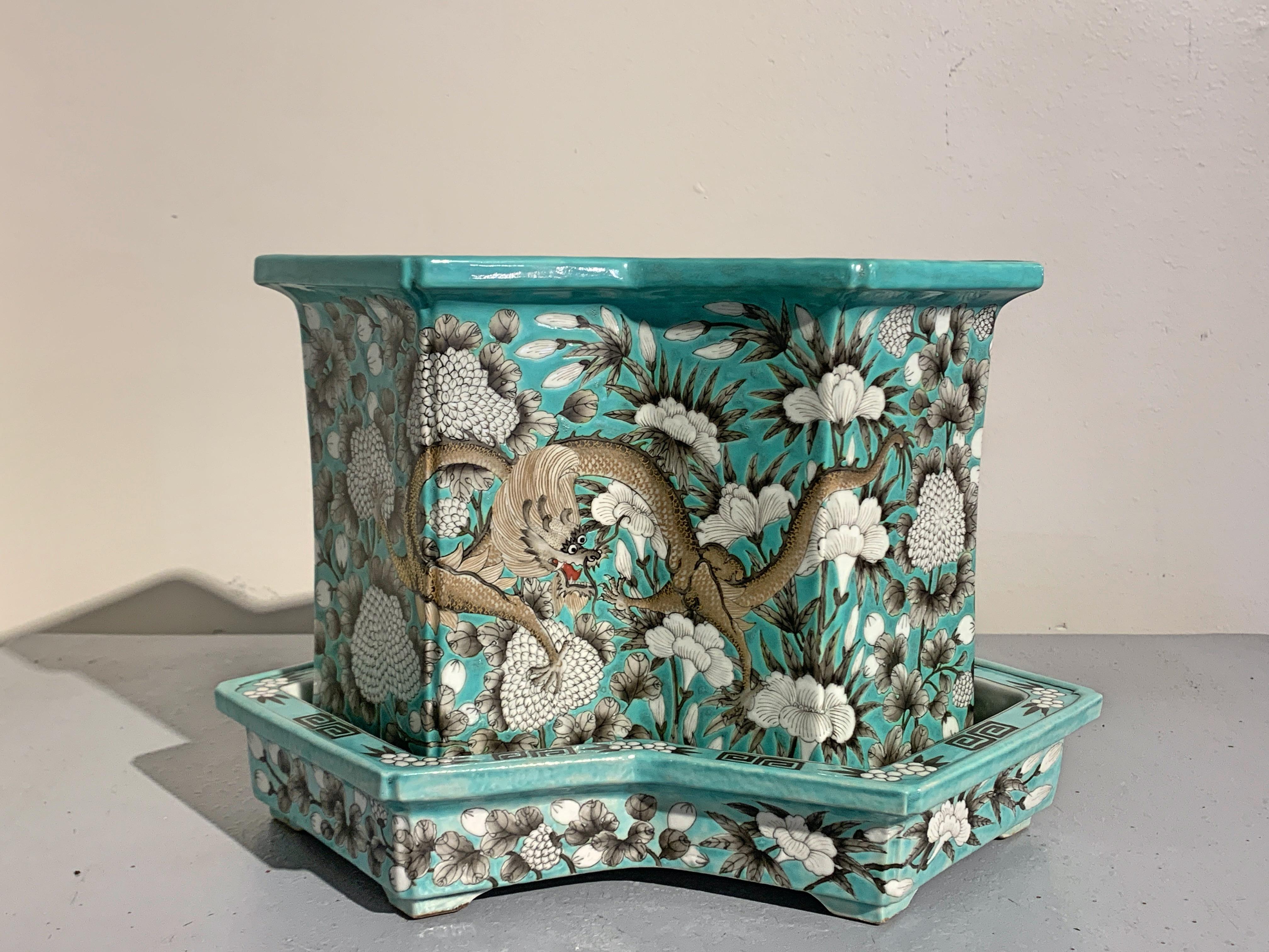 A finely painted Chinese Dayazhai style turquoise glazed double lozenge shaped porcelain jardiniere and underplate with grisaille and gilt decoration, mid-20th century, China. 

The tall porcelain jardiniere of double lozenge (fangsheng) form, an