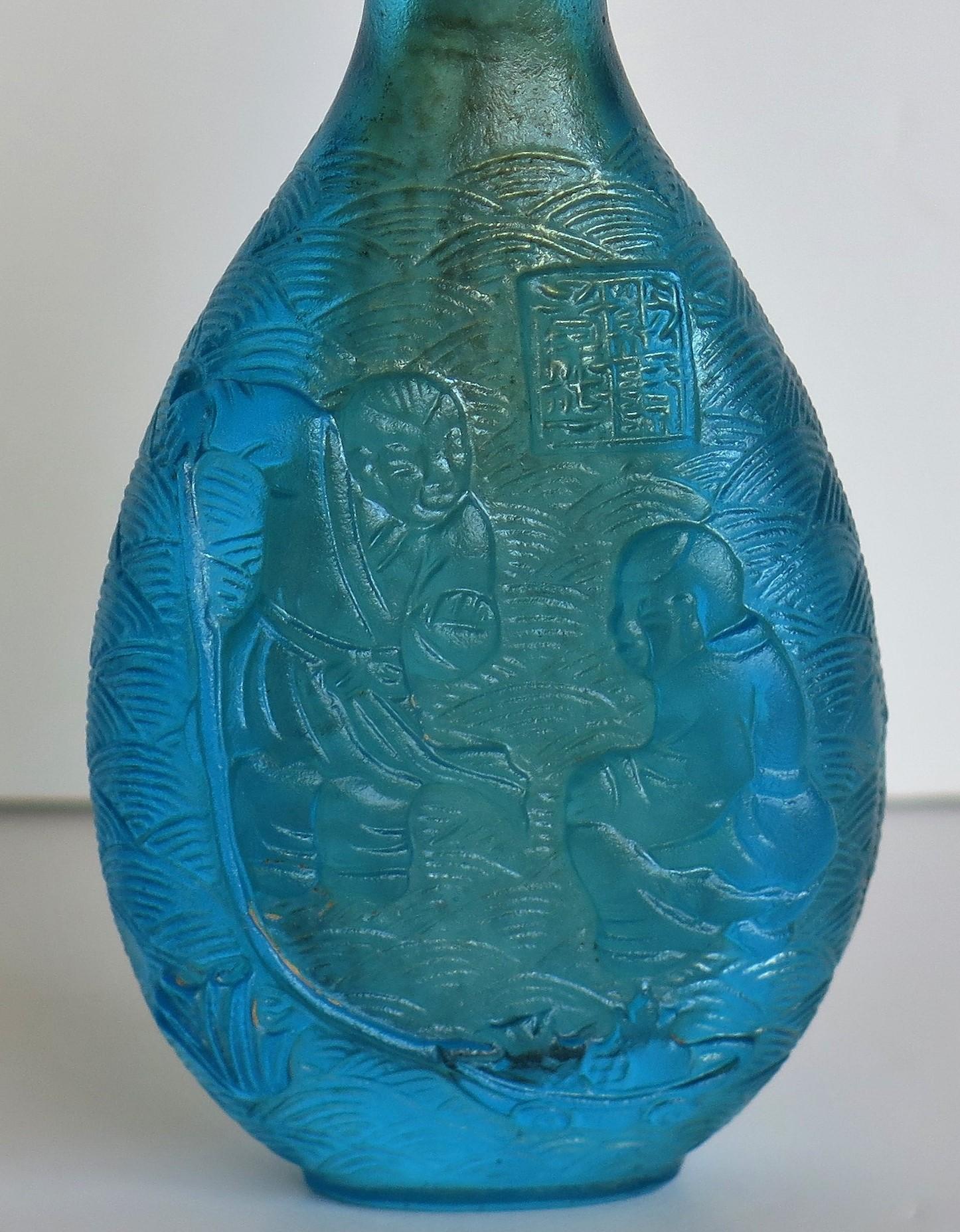 Chinese Turquoise Glass Snuff Bottle with Carved Figures and Spoon Top 3