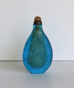 Chinese Turquoise Glass Snuff Bottle with Carved Figures and Spoon Top