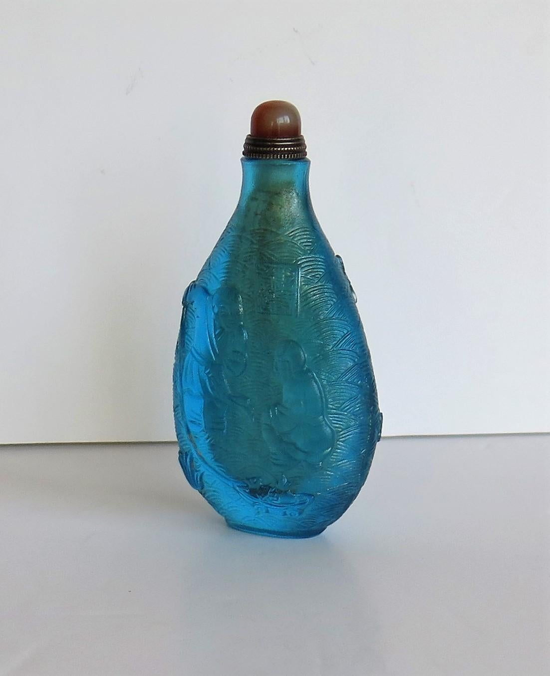 Qing Chinese Turquoise Glass Snuff Bottle with Carved Figures and Spoon Top
