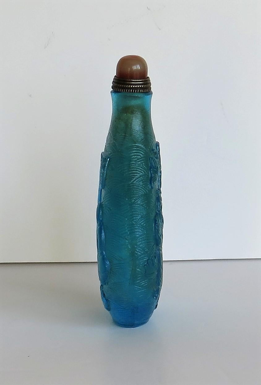 Hand-Crafted Chinese Turquoise Glass Snuff Bottle with Carved Figures and Spoon Top