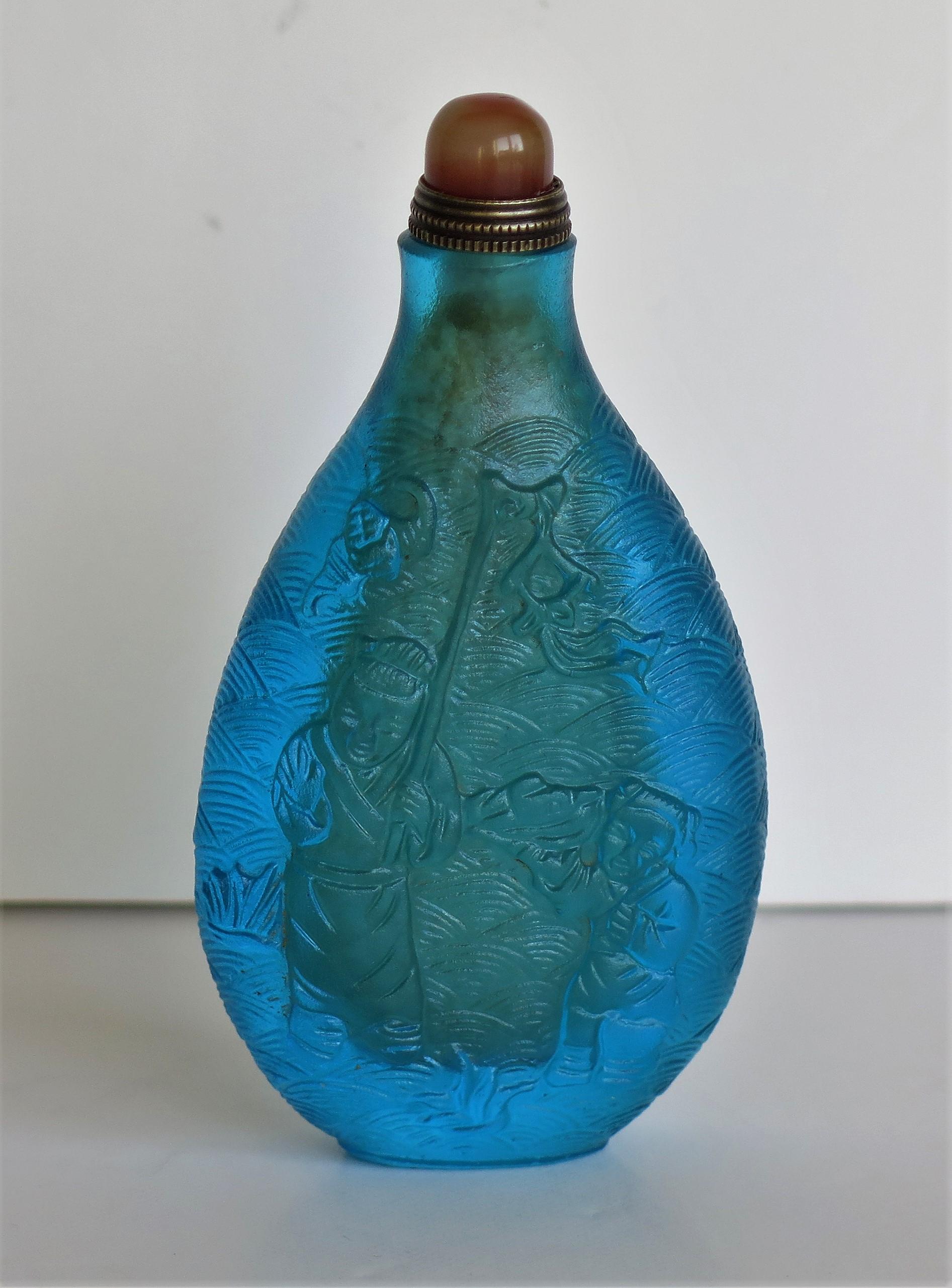 Chinese Turquoise Glass Snuff Bottle with Carved Figures and Spoon Top 2
