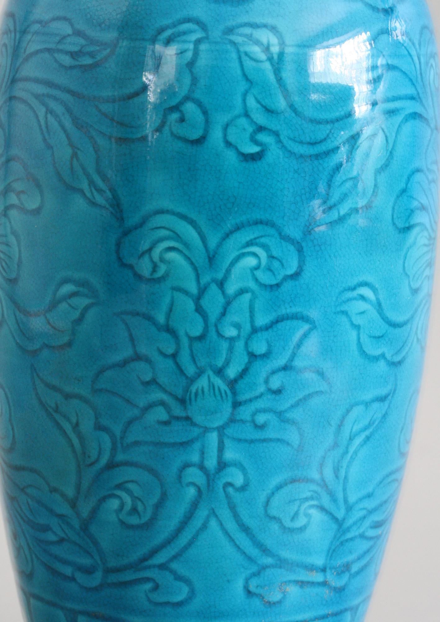 A very fine Chinese porcelain vase decorated with incised floral designs and finished in a bright turquoise glaze believed to date from the 19th or early 20th century. This finely potted Rouleau shaped vase has an incised border around the foot with