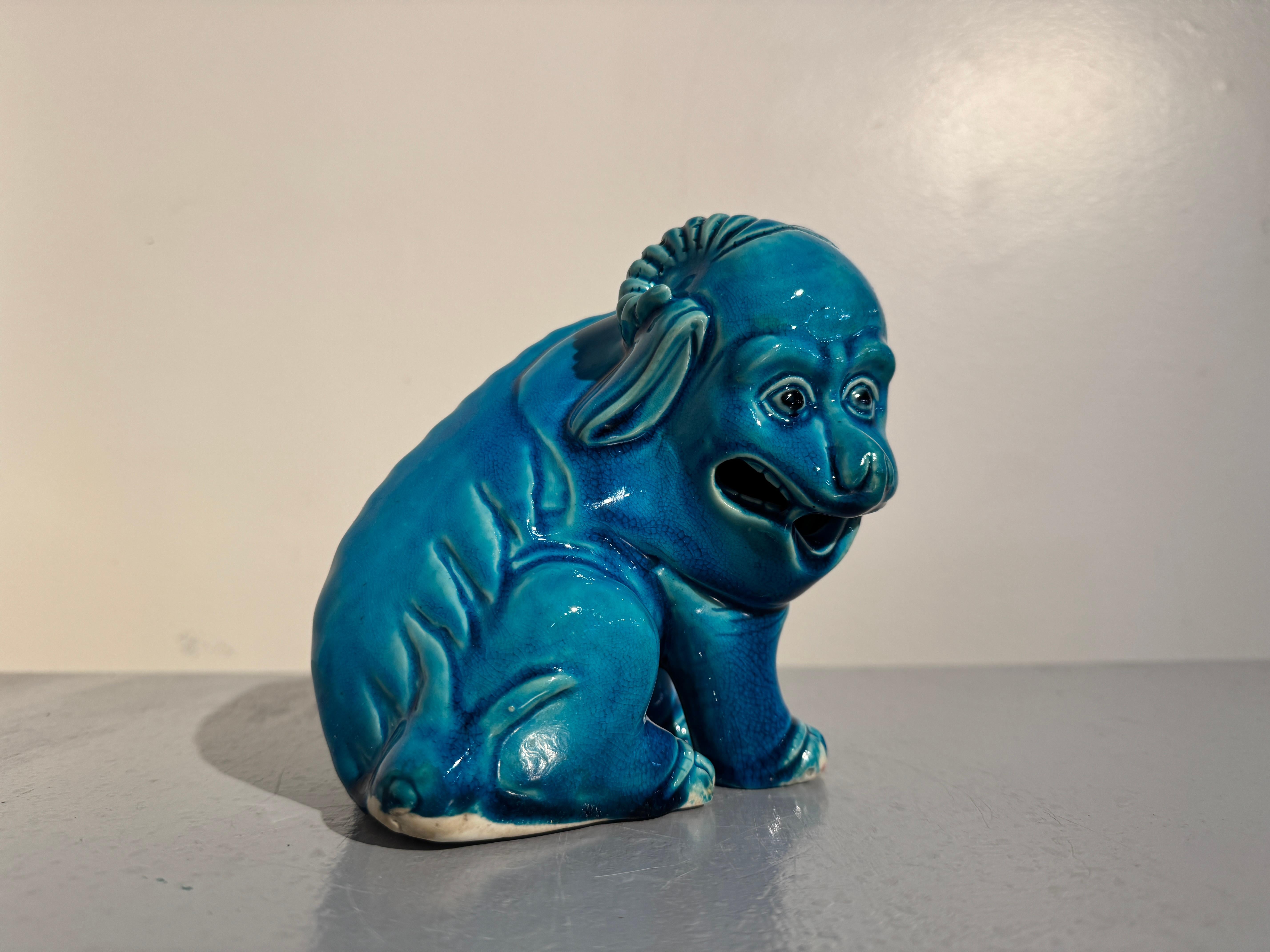 An unusual and absolutely charming Chinese porcelain turquoise glazed mythical beast, possibly a qilin or a pixiu, very late Qing Dynasty, circa 1900, China. 

The strange figure is chimeric, with pawed lions feet, long, floppy goat ears, a pair of