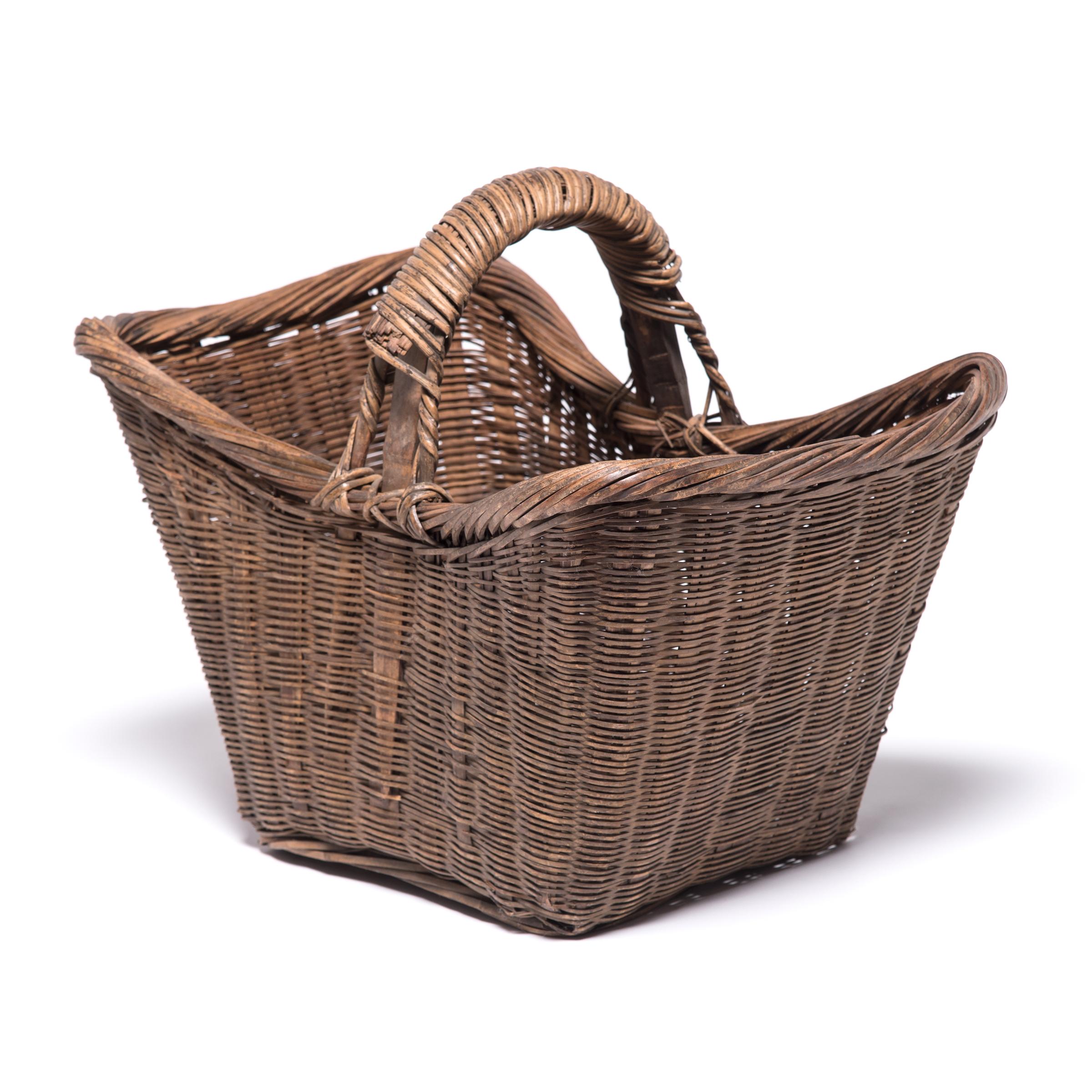It's easy to imagine someone, long ago, walking to market on a beautiful summer day with this beautiful basket slung over their arm. Basket making is an ancient and humble craft, but in the hands of a truly skilled weaver willow branches, like