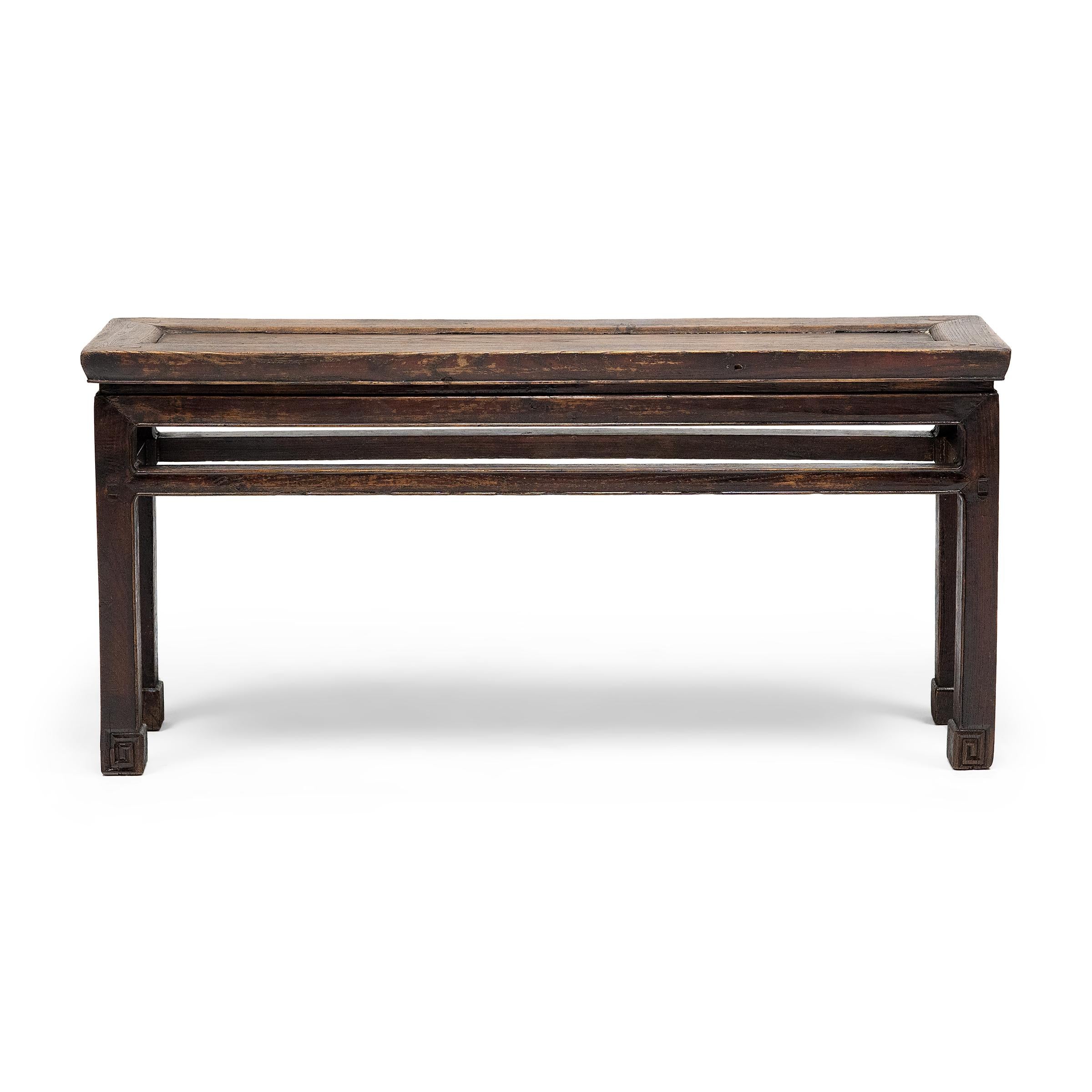 This early 19th-century bench would have originally resided in the courtyard of a Qing-dynasty home to provide much-needed outdoor seating on hot summer days. The bench is designed in a classic Ming style, with a floating panel top, waisted apron,