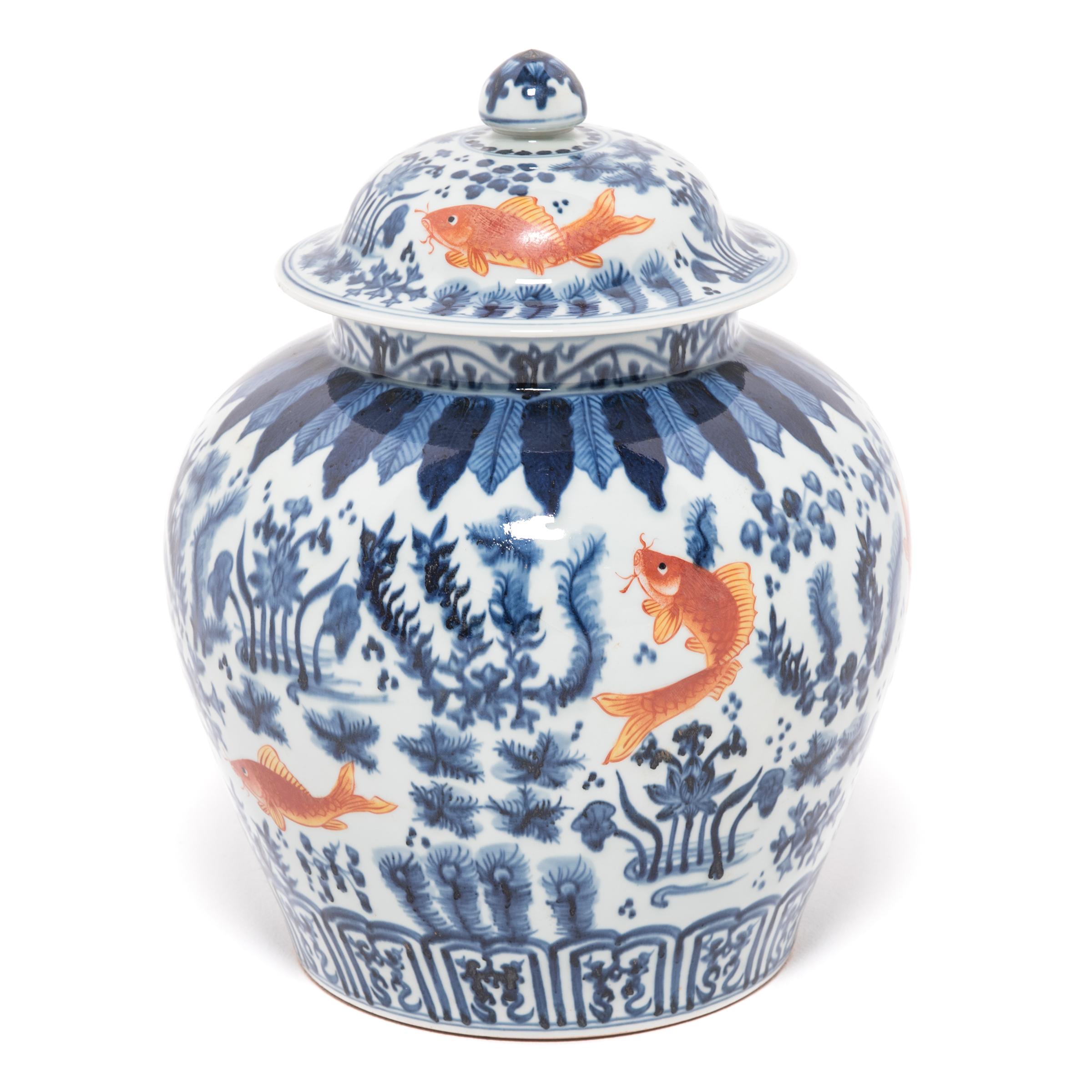 Revered for centuries for its elegant designs of rich cobalt blue and pure white, traditional Chinese blue and white porcelain lives on in this covered jar hand painted with fish and flora of the sea, traditional symbols of prosperity and harmony.