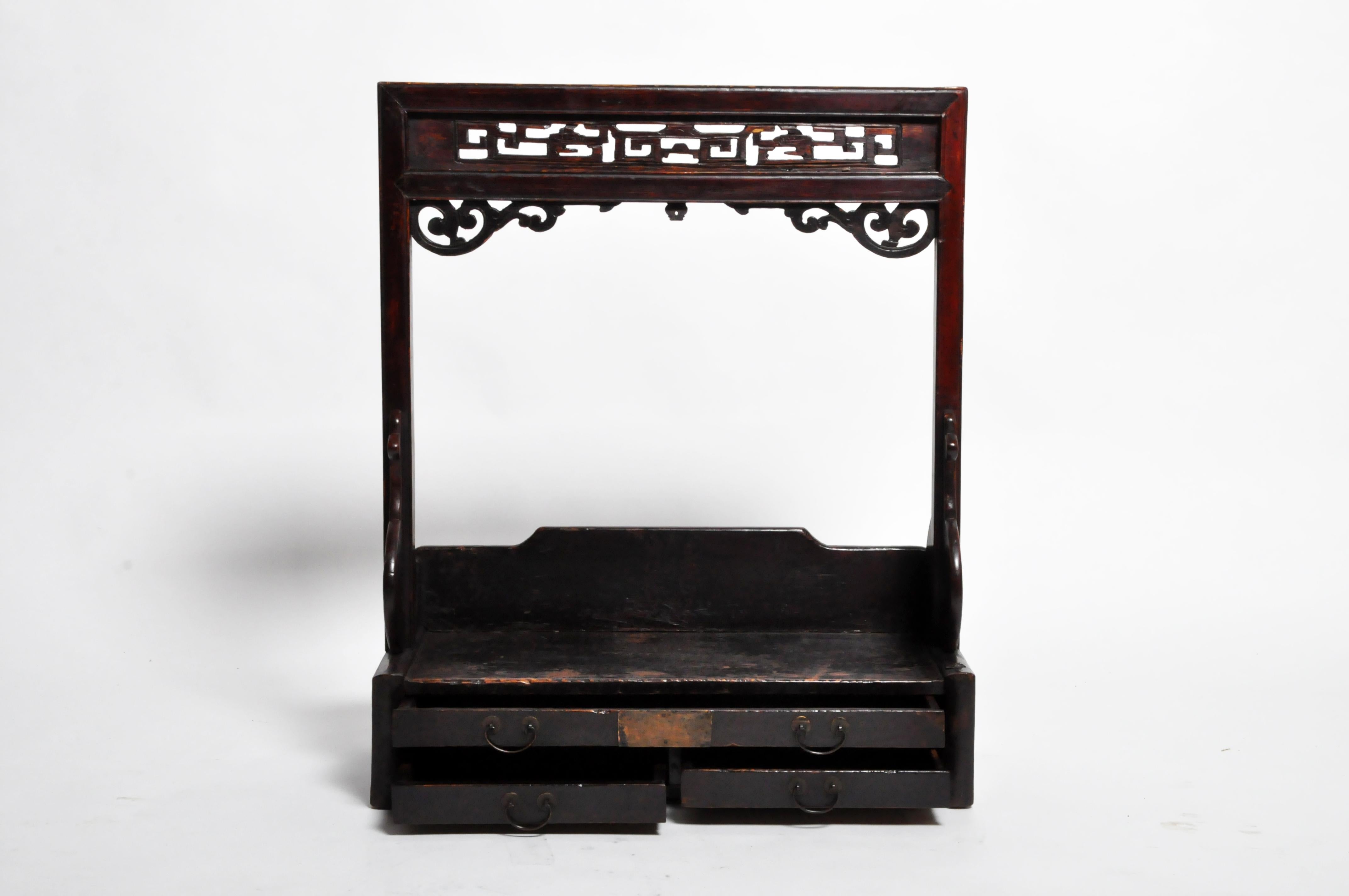 This lacquered wooden shelf probably held a mirror, jars of cosmetics, and articles of personal toilette. The piece has its original finish and the wood is in good condition. Origin: Shanghai, China, circa 1920.
 