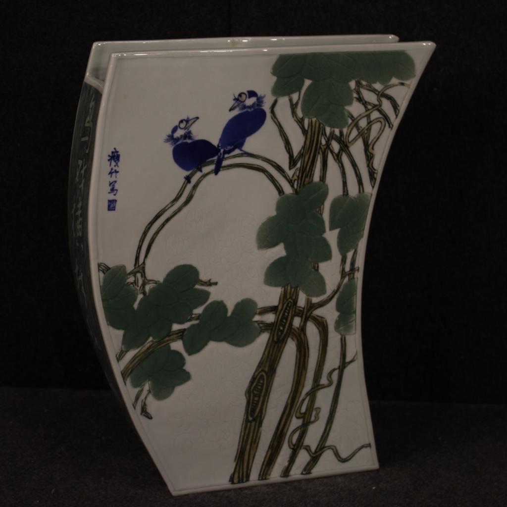 Chinese vase from the early 21st century. Jingdezhen ceramic work enameled and hand painted with oriental lettering, floral and animal elements. Vase with a particular shape and great impact ideal to be displayed as a furnishing accessory, for