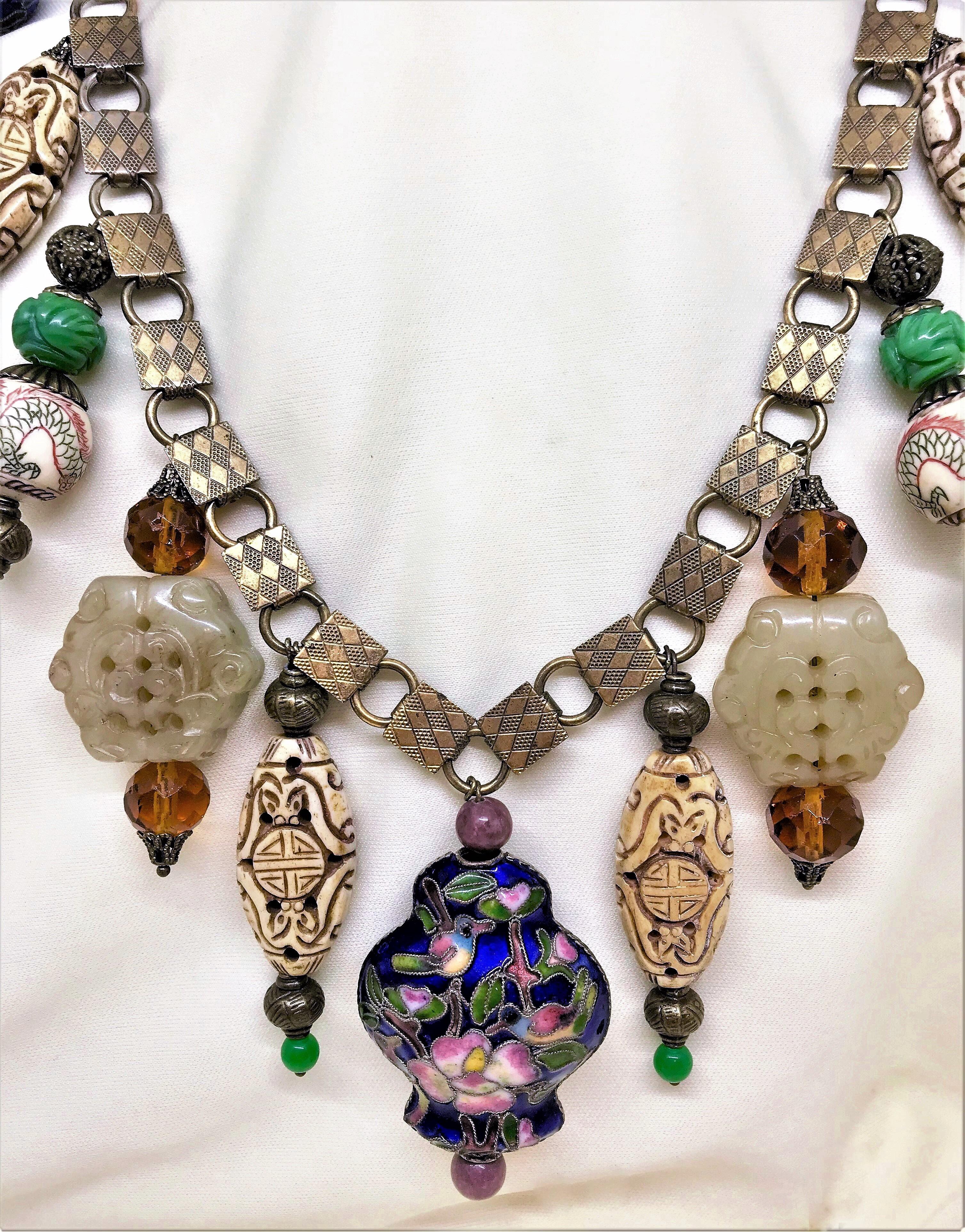 A newly created necklace from Little Treasures made from early 1900s ornate brass book-chain and a mix of contemporary and vintage Chinese beads of carved bone, porcelain dragons, cloisonné and carved Chinese Celadon beads. The necklace is