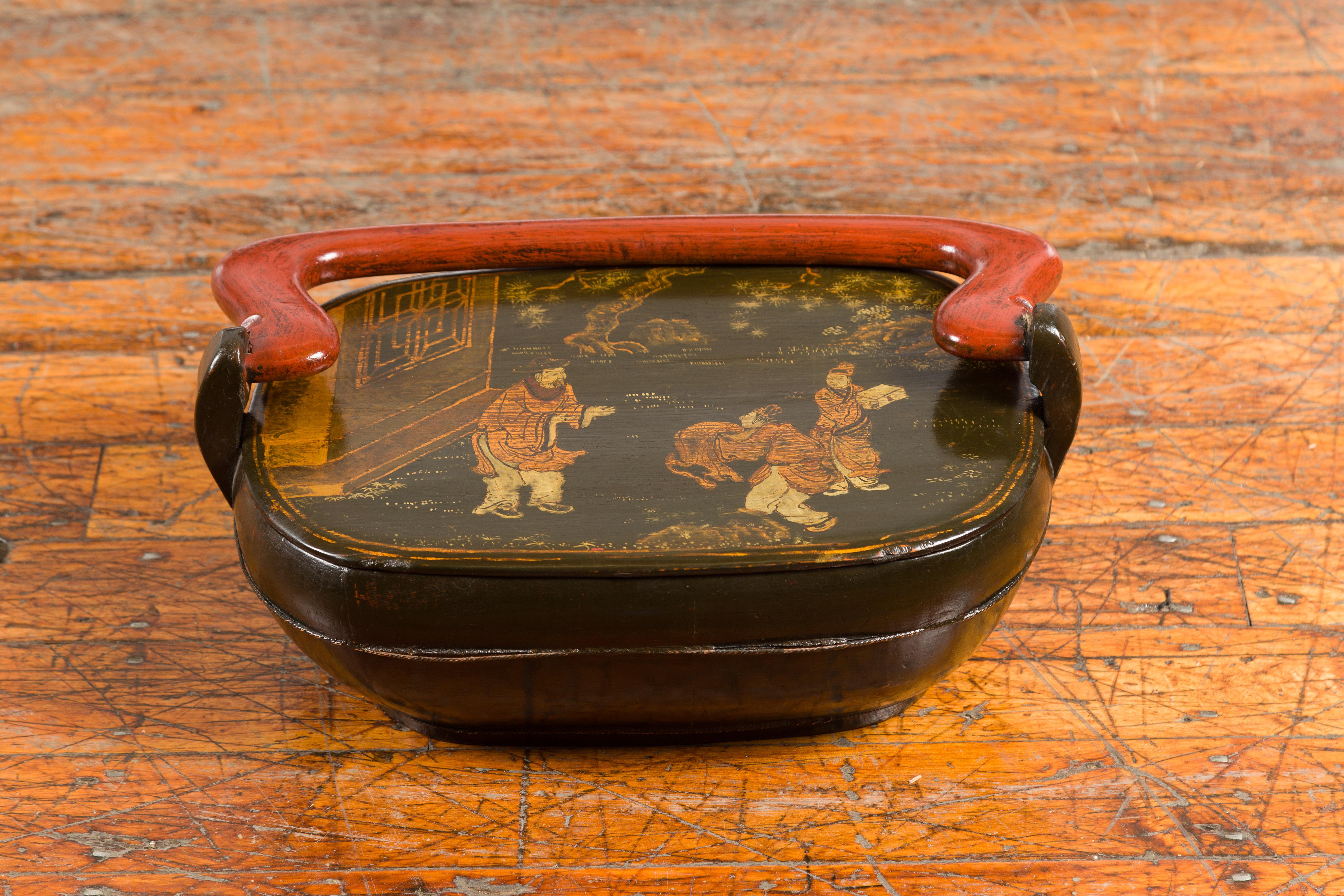 A Chinese vintage black lacquer lidded box from the mid 20th century, with hand-painted Chinoiserie décor. Created in China during the midcentury period, this black lacquer box showcases an oval lid adorned with a delicate Chinoiserie décor. Topped