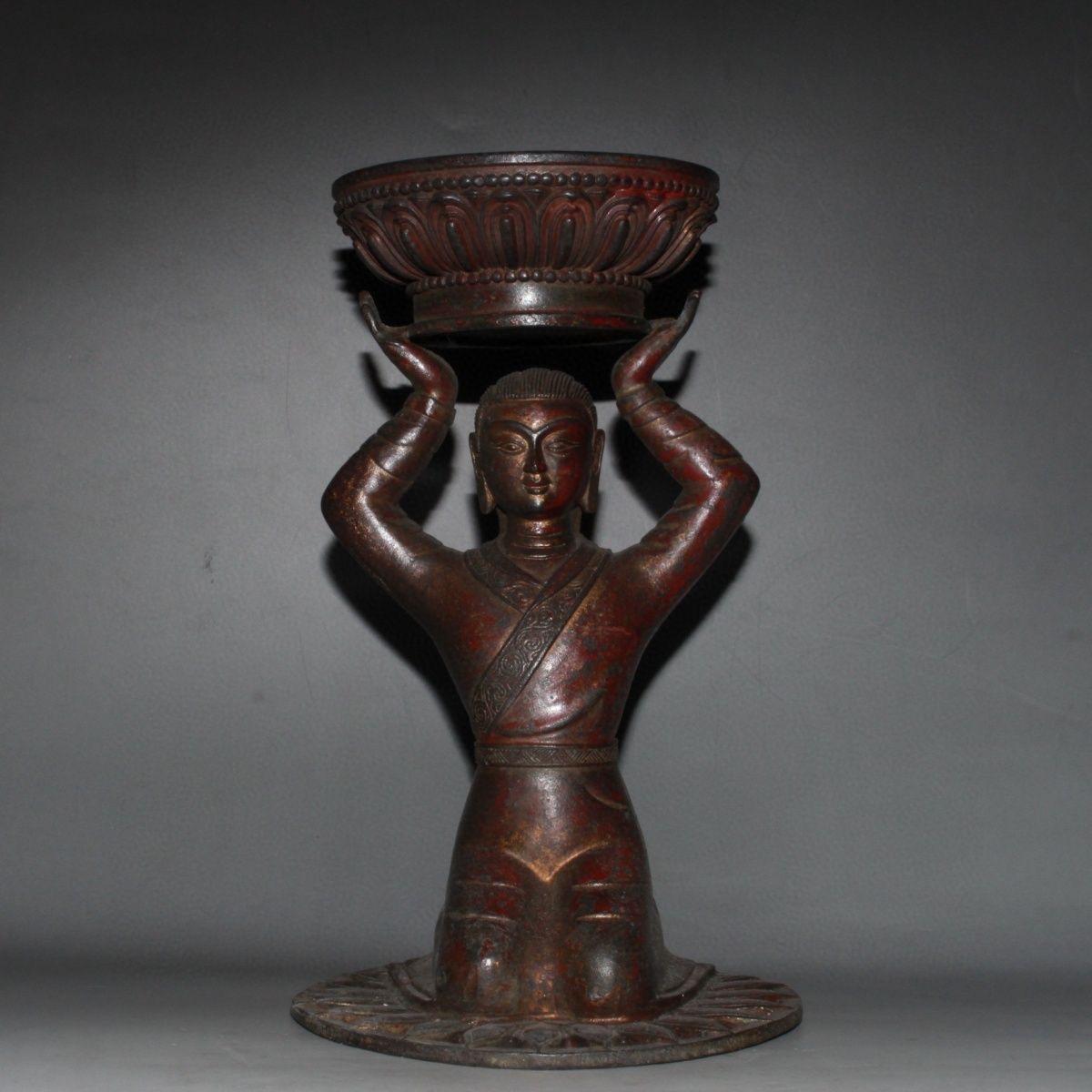 This Chinese Vintage Bronze Kneeling Down Buddha Candle Holder Statue is rare and special.

Unlike traditional Buddha sculptures that depict the figure seated in meditation, this particular piece show the Buddha in a kneeling position with both