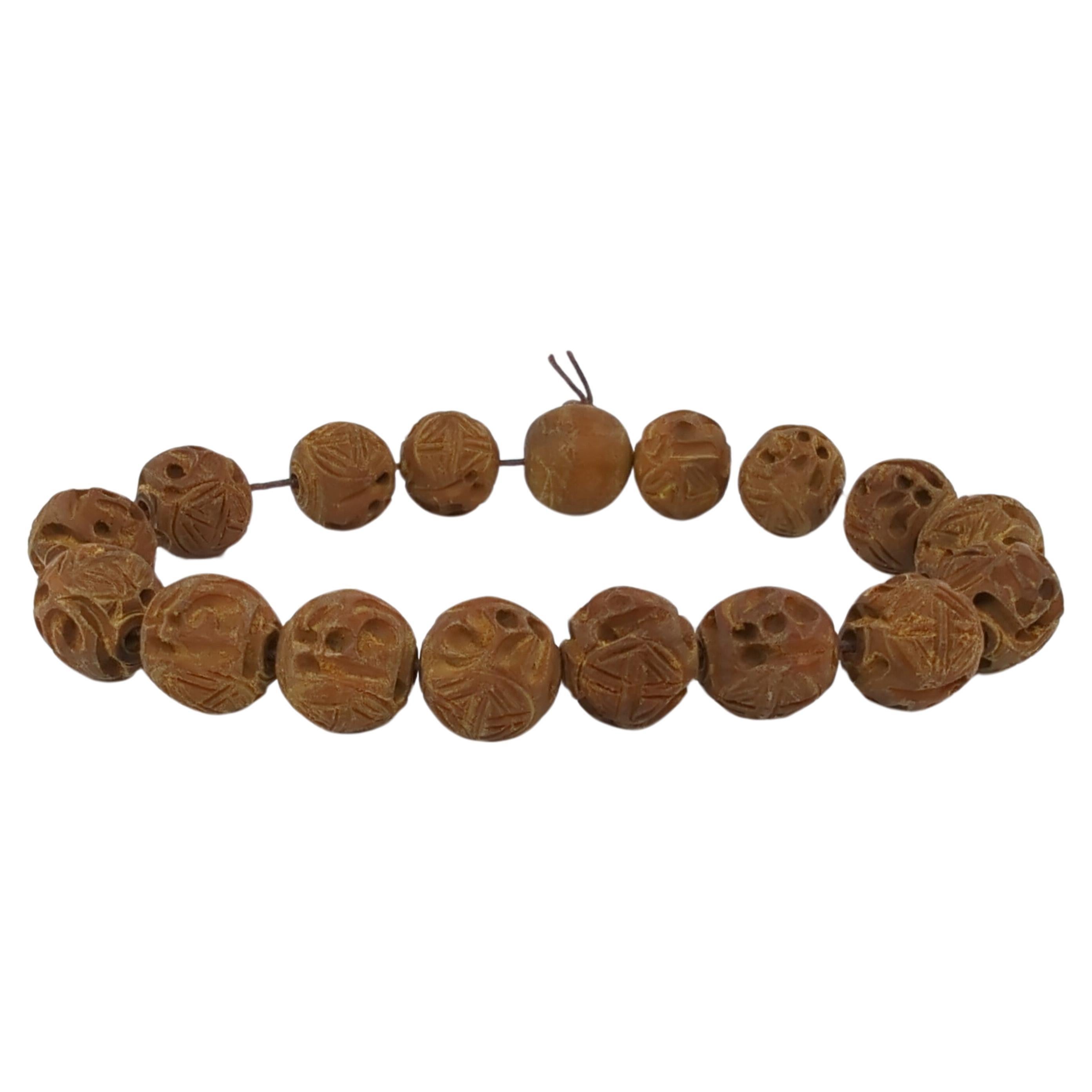 Chinese Vintage Carved Sandalwood 17 Beads Bracelet On Old String In Good Condition For Sale In Richmond, CA