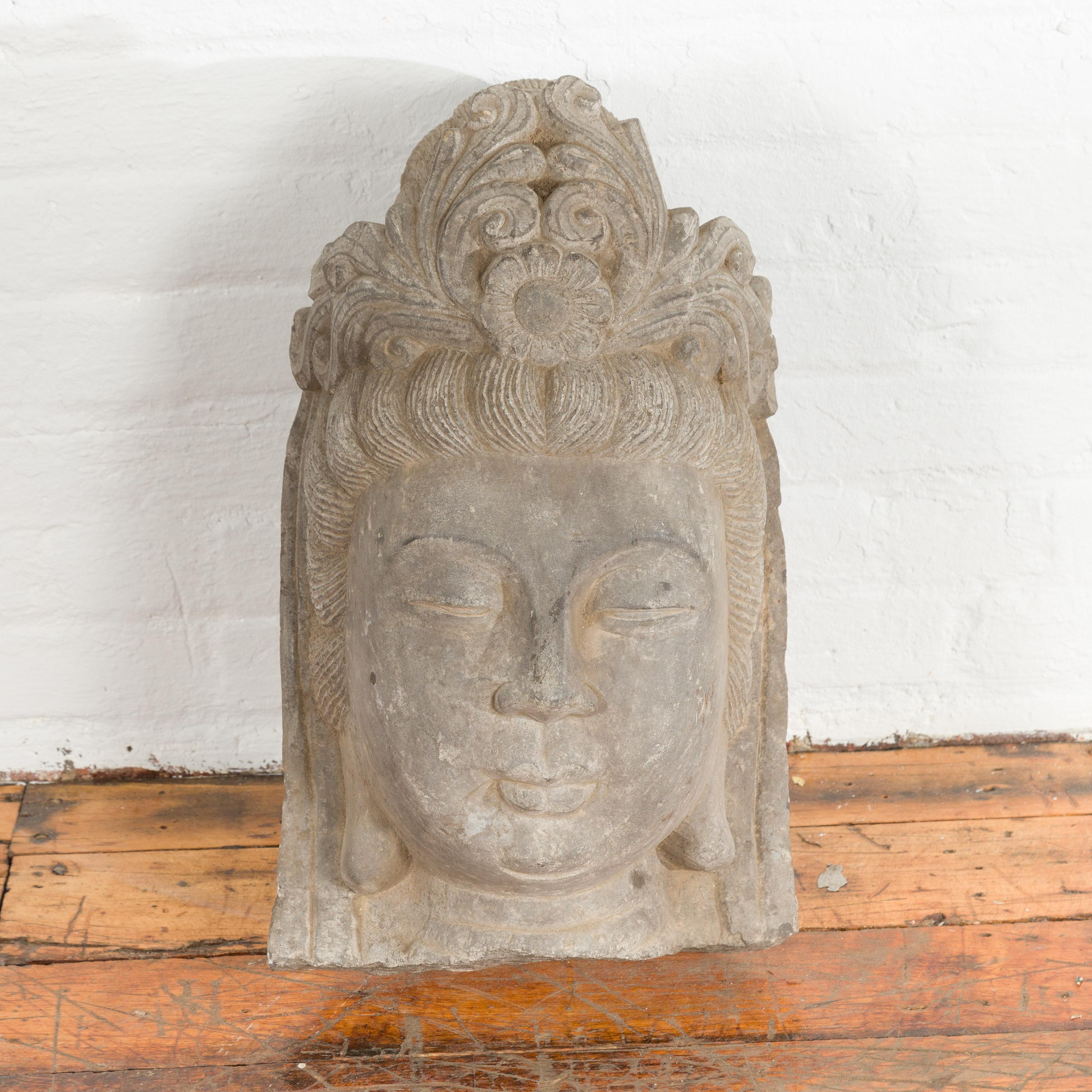 A large Chinese vintage carved stone bust of Guanyin from the mid 20th century. Found in southern China, this large carved stone bust captivates us with its calm depiction of Guanyin, Bodhisattva of Compassion. Topped with an ornate headdress,